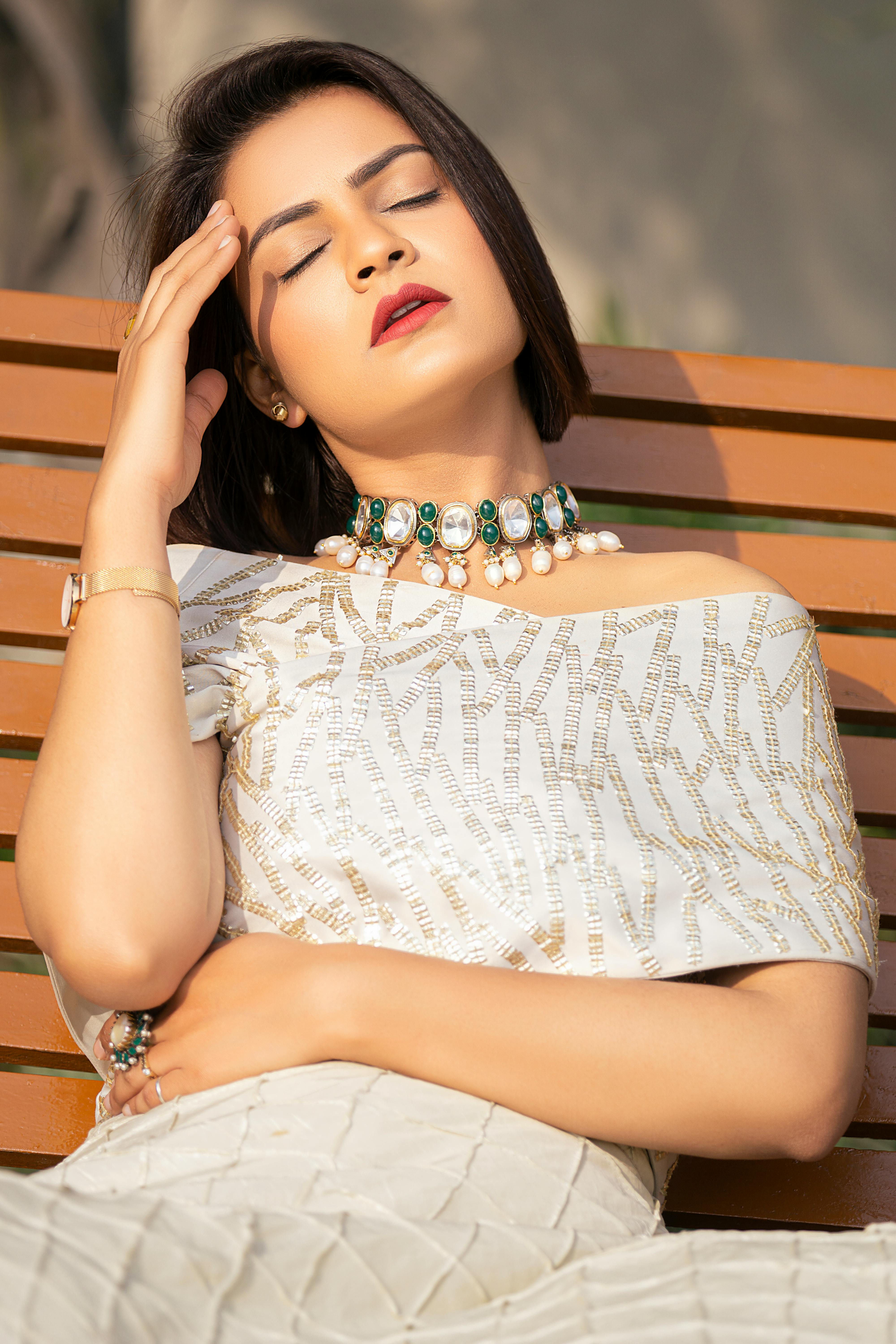 A woman sitting with her hand on her head | Source: Pexels