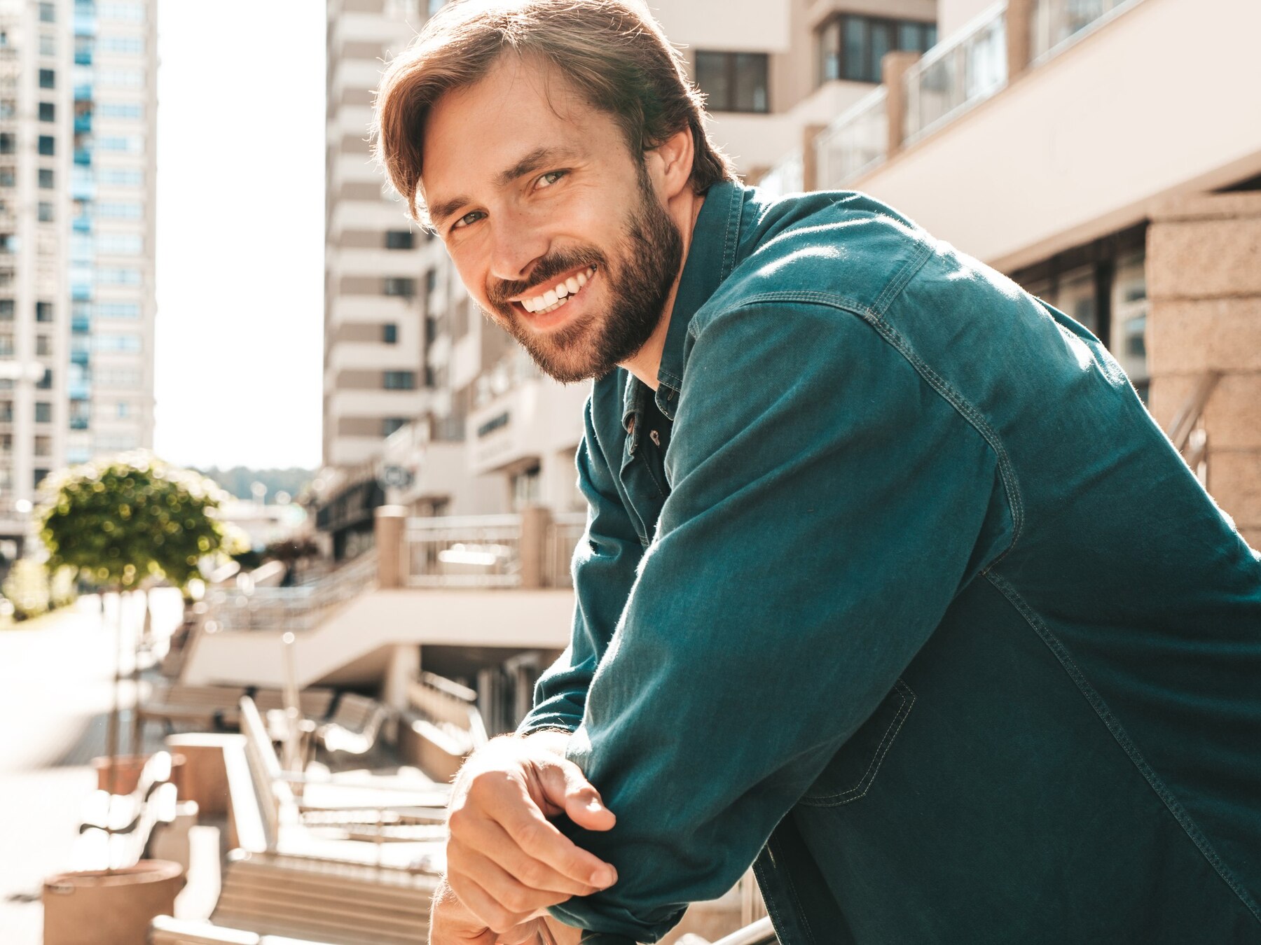 A man smiling outdoors | Source: Freepik