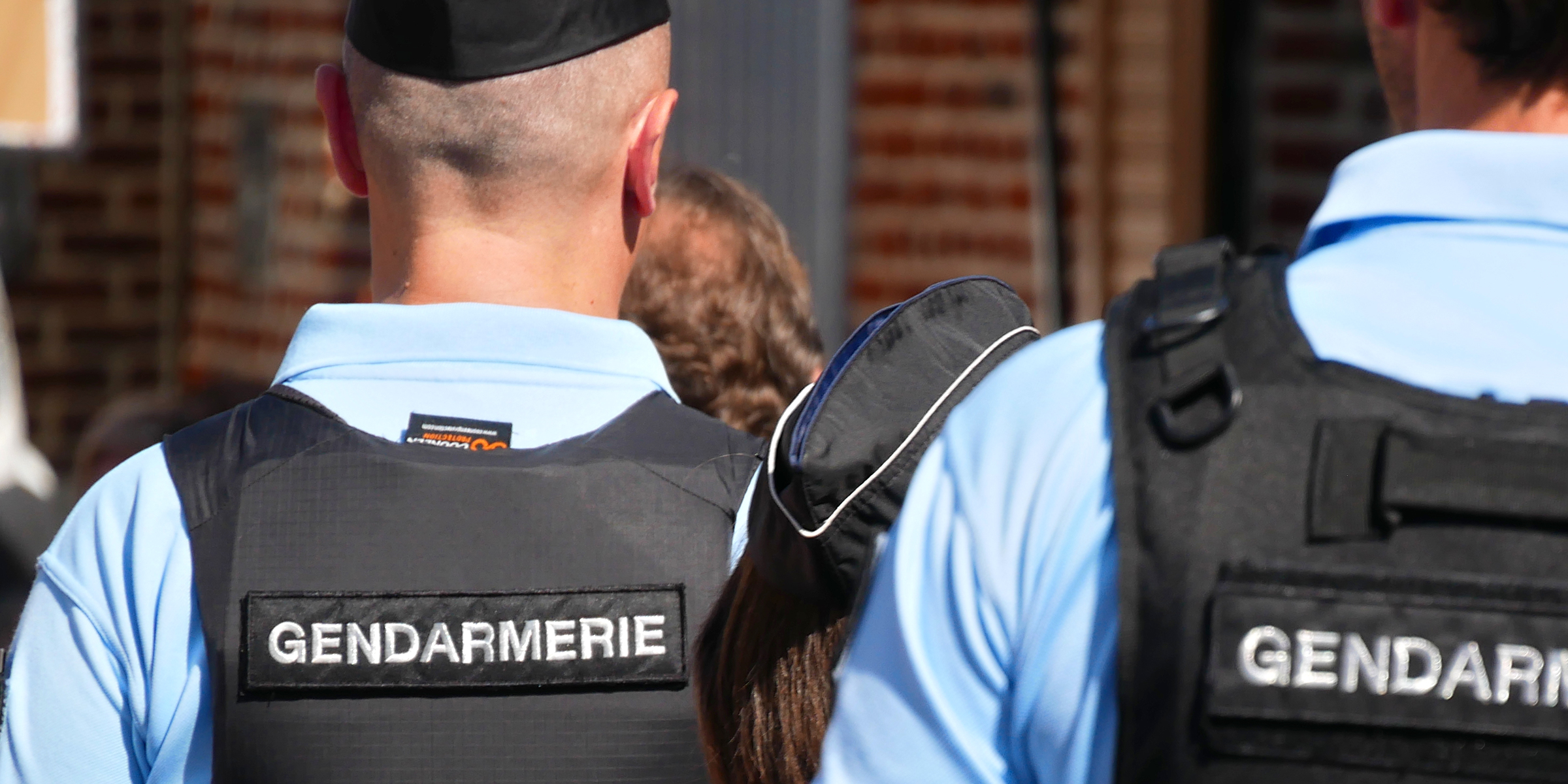 Des gendarmes vus de dos portant des gilets pare-balles | Source : Getty Images