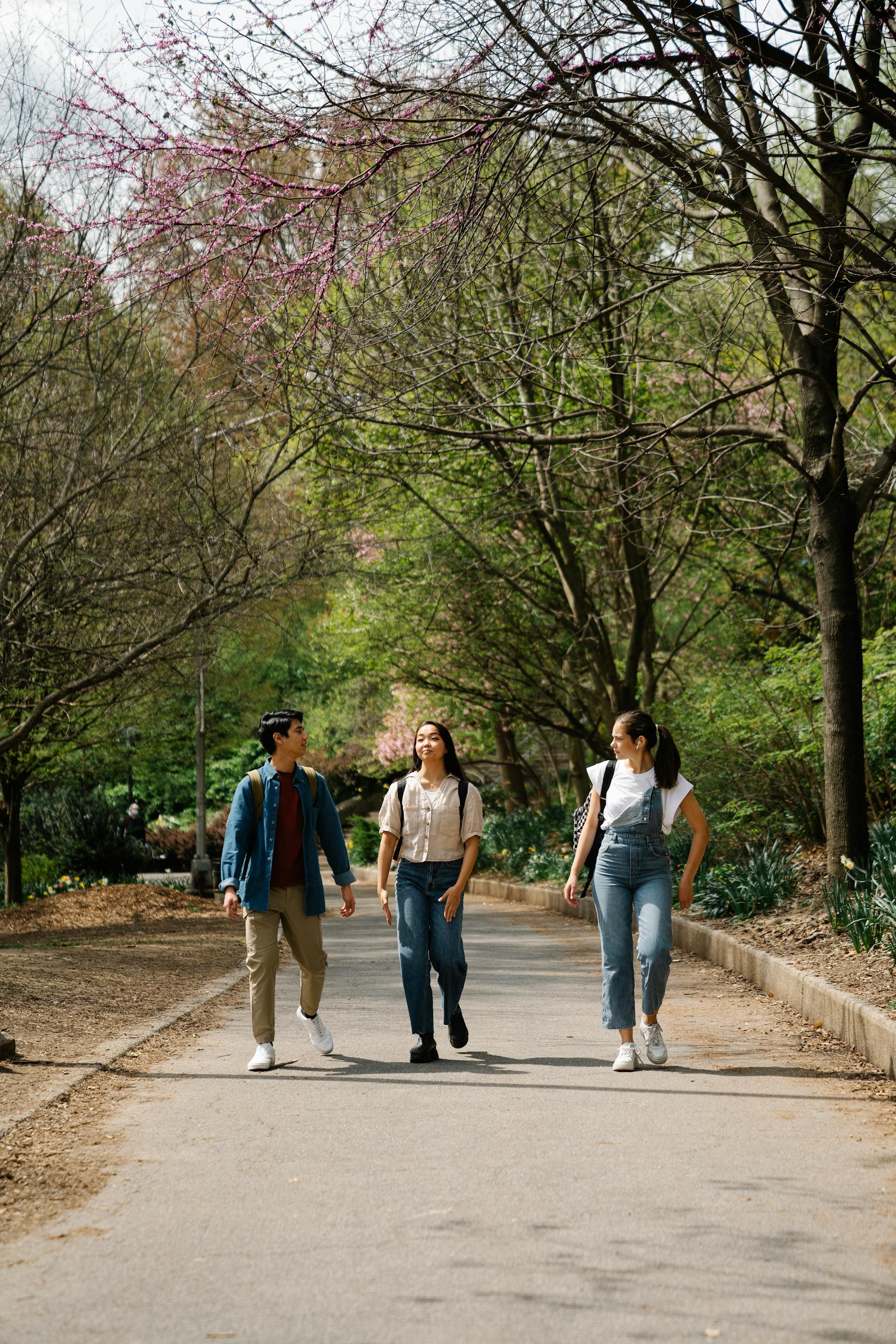 Trois jeunes gens marchant sur un sentier | Source : Pexels