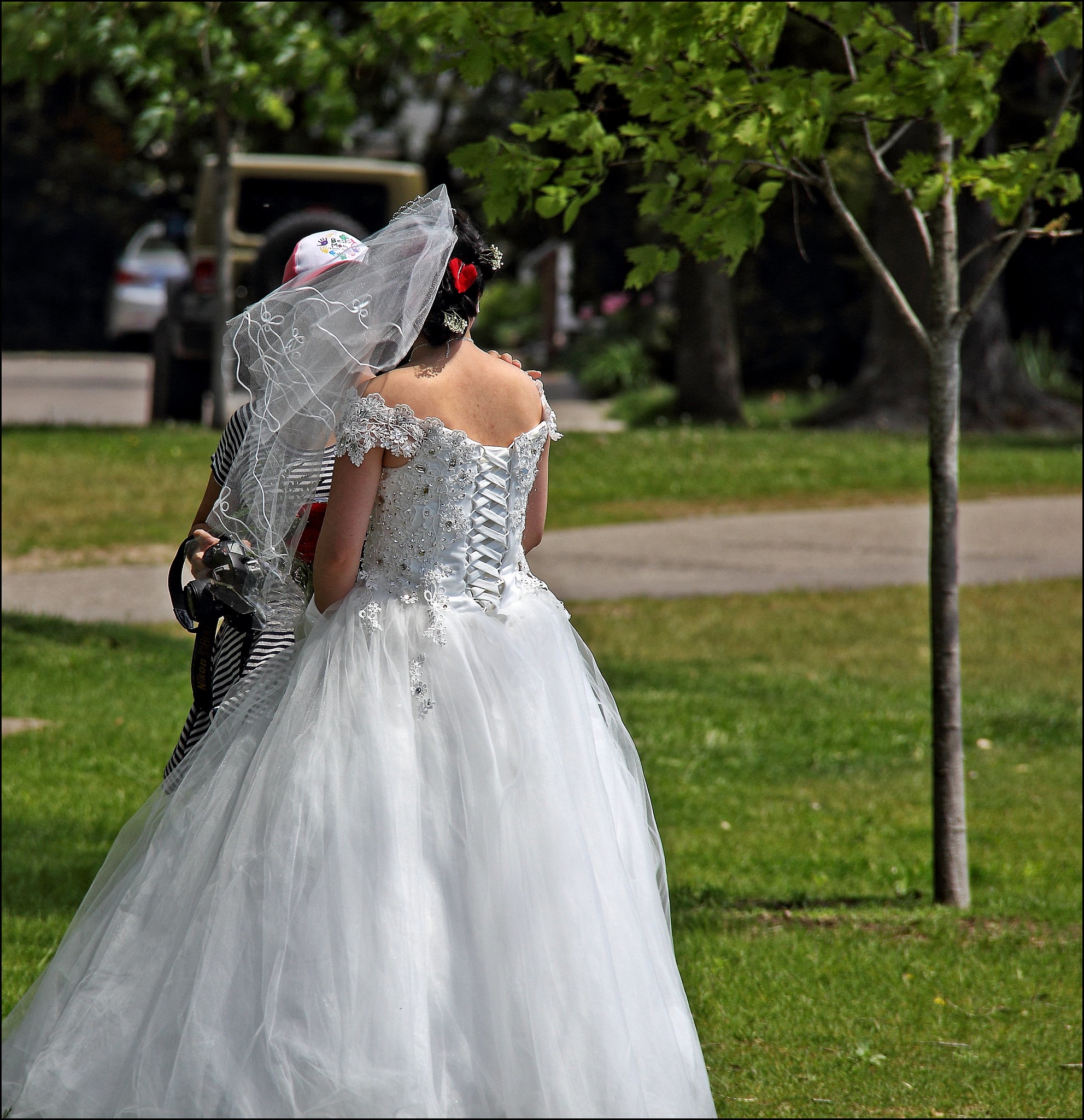 Vue arrière d'une mariée debout à l'extérieur | Source : Flickr