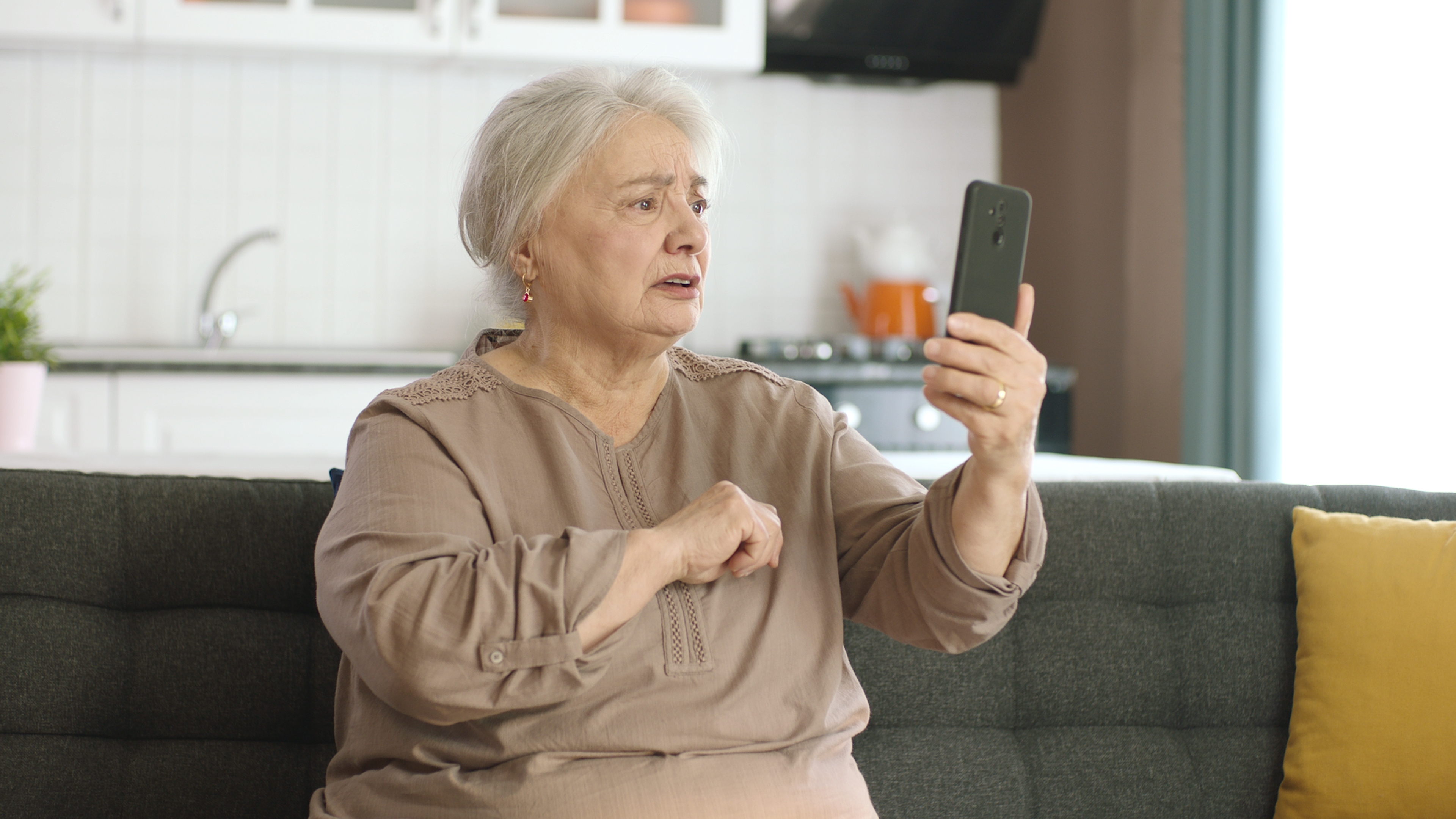 Femme âgée en colère en train de regarder son téléphone | Source : Shutterstock