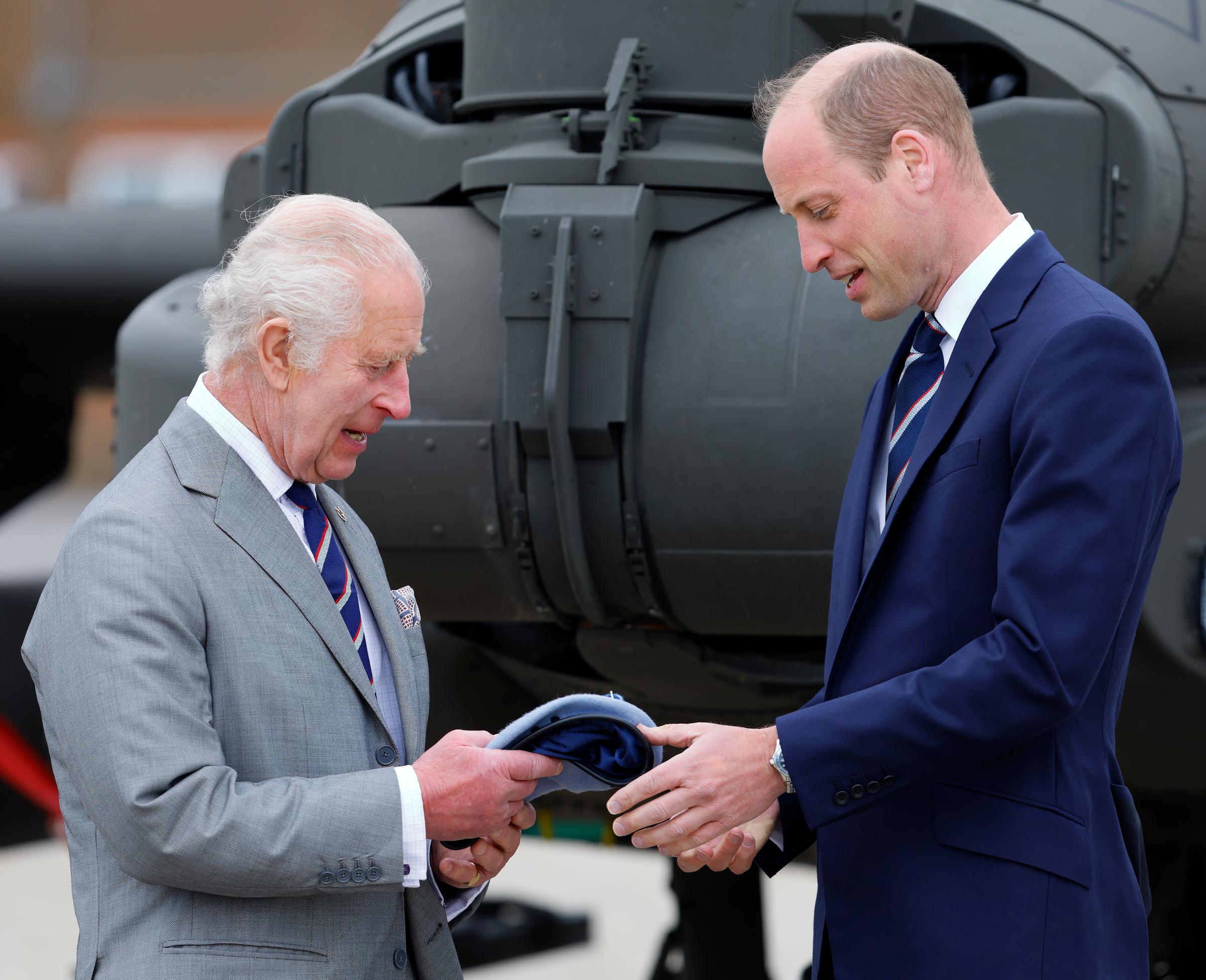 Le roi Charles III remet au prince William le béret bleu et la ceinture de l'Army Air Corps lors d'une remise de rôle à Middle Wallop, en Angleterre, le 13 mai 2024 | Source : Getty Images