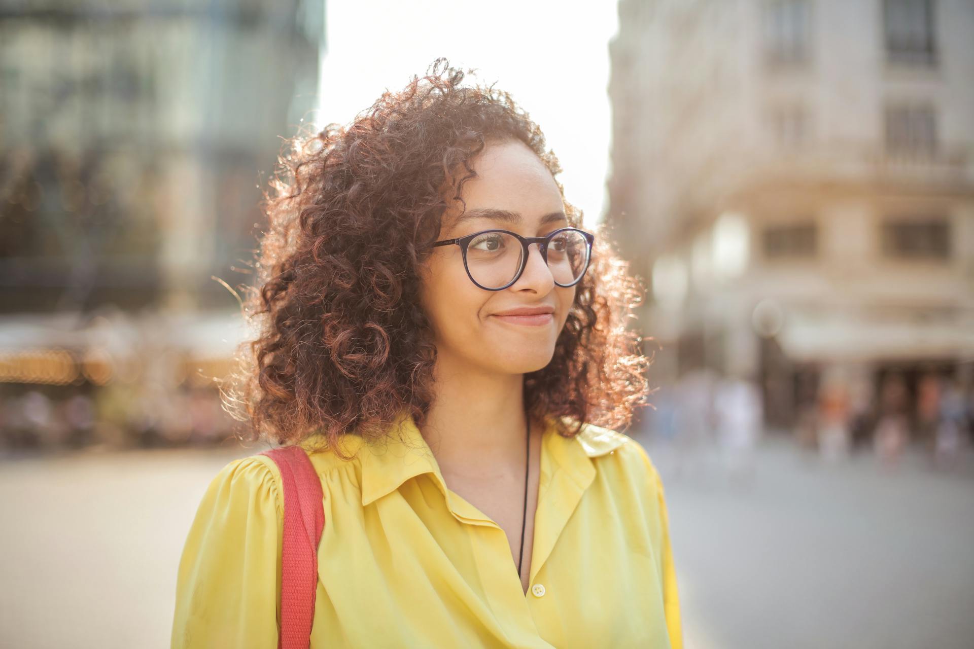 Une femme sur un trottoir souriant à quelqu'un | Source : Pexels