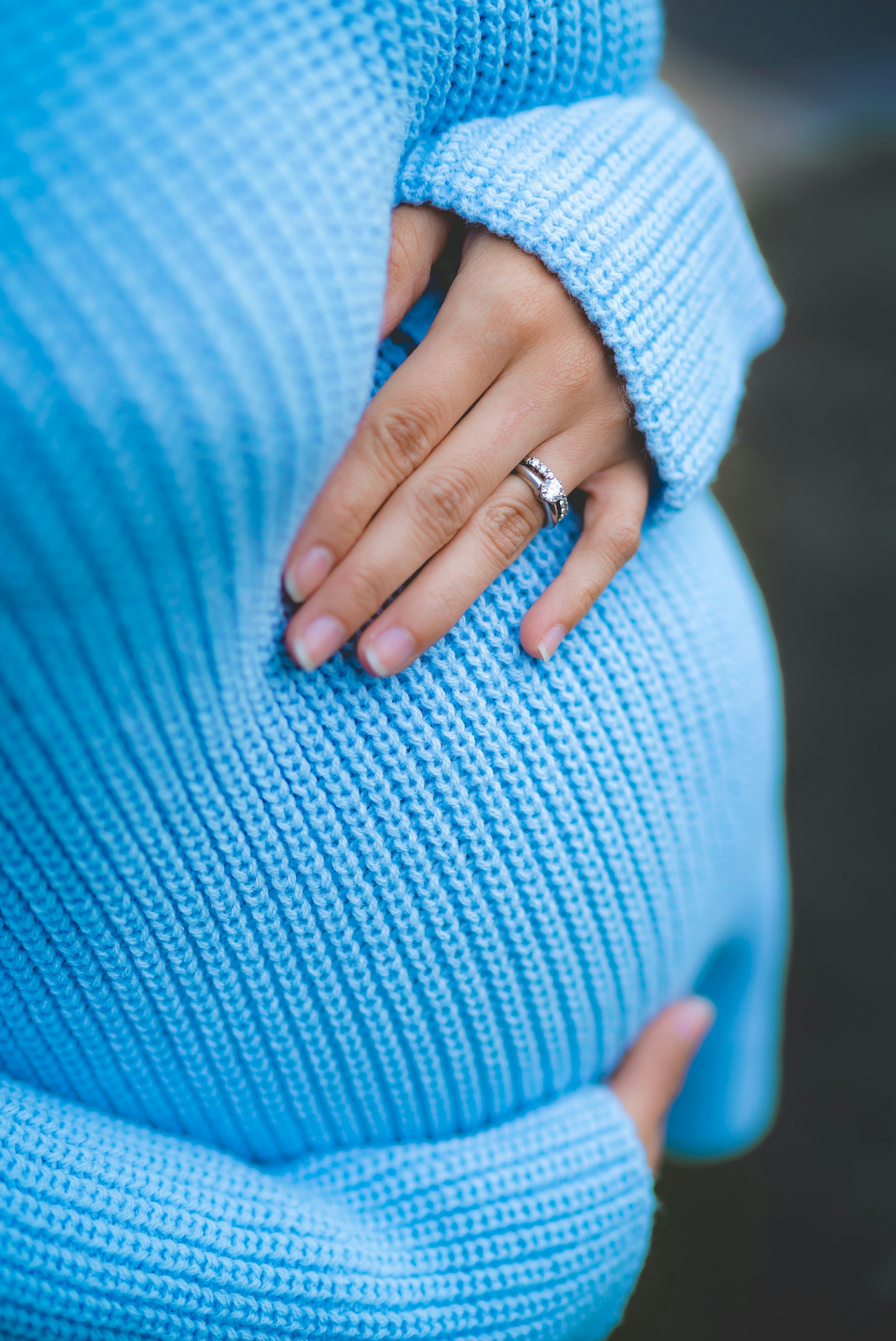 Cropped image of a pregnant woman holding her belly | Source: Unsplash