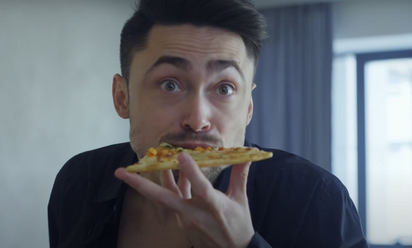 Homme mangeant une pizza | Source : YouTube / DramatizeMe