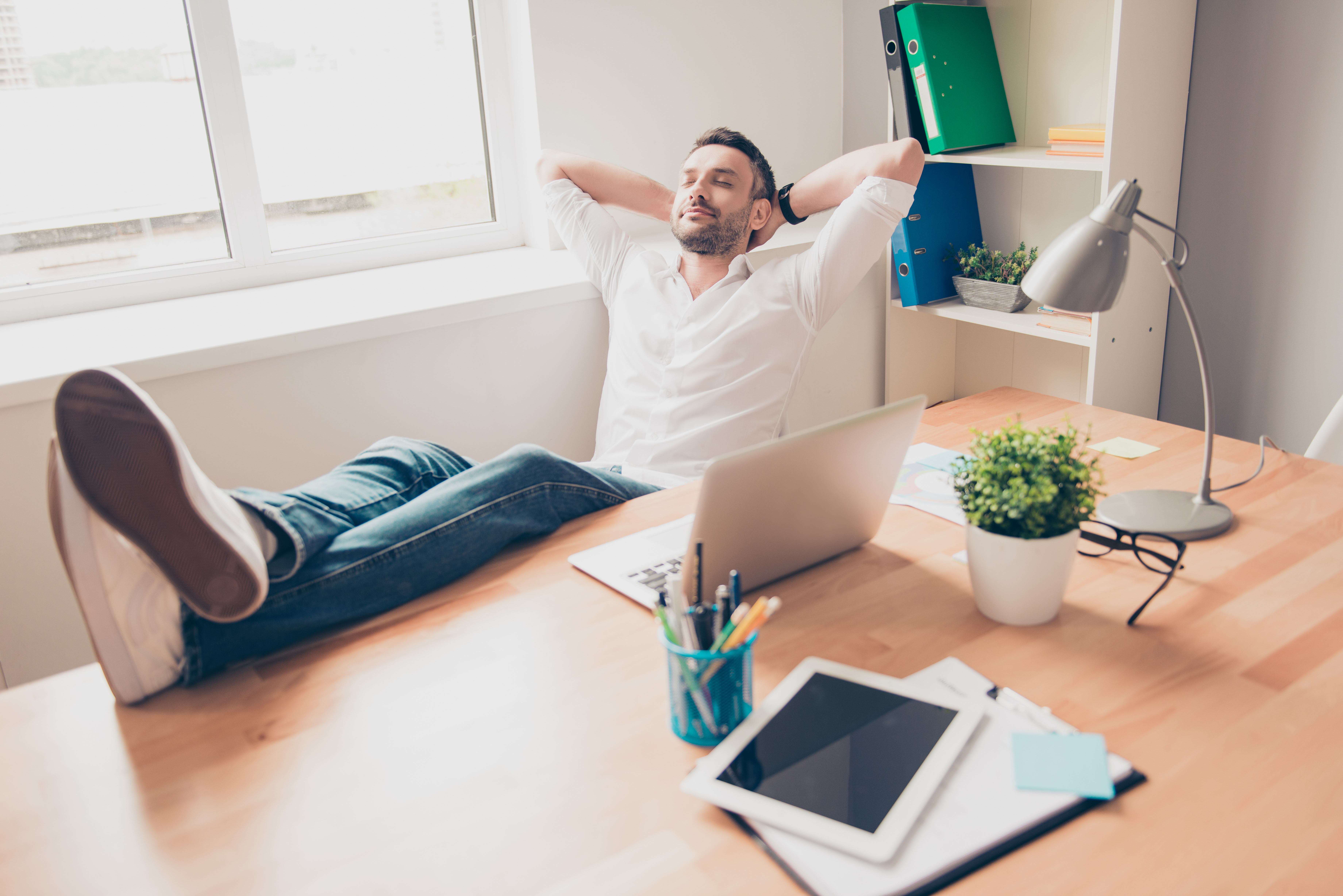 El hombre pone las piernas sobre la mesa como un jefe. | Fuente: Shutterstock