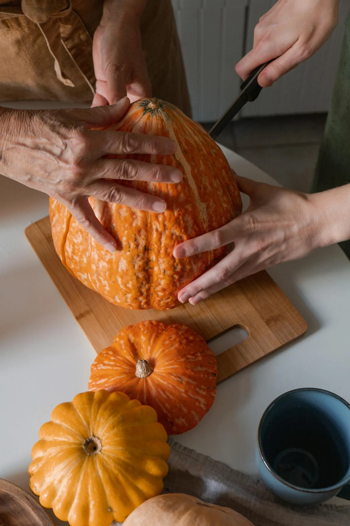 Deux femmes découpent une citrouille | Source : Pexels