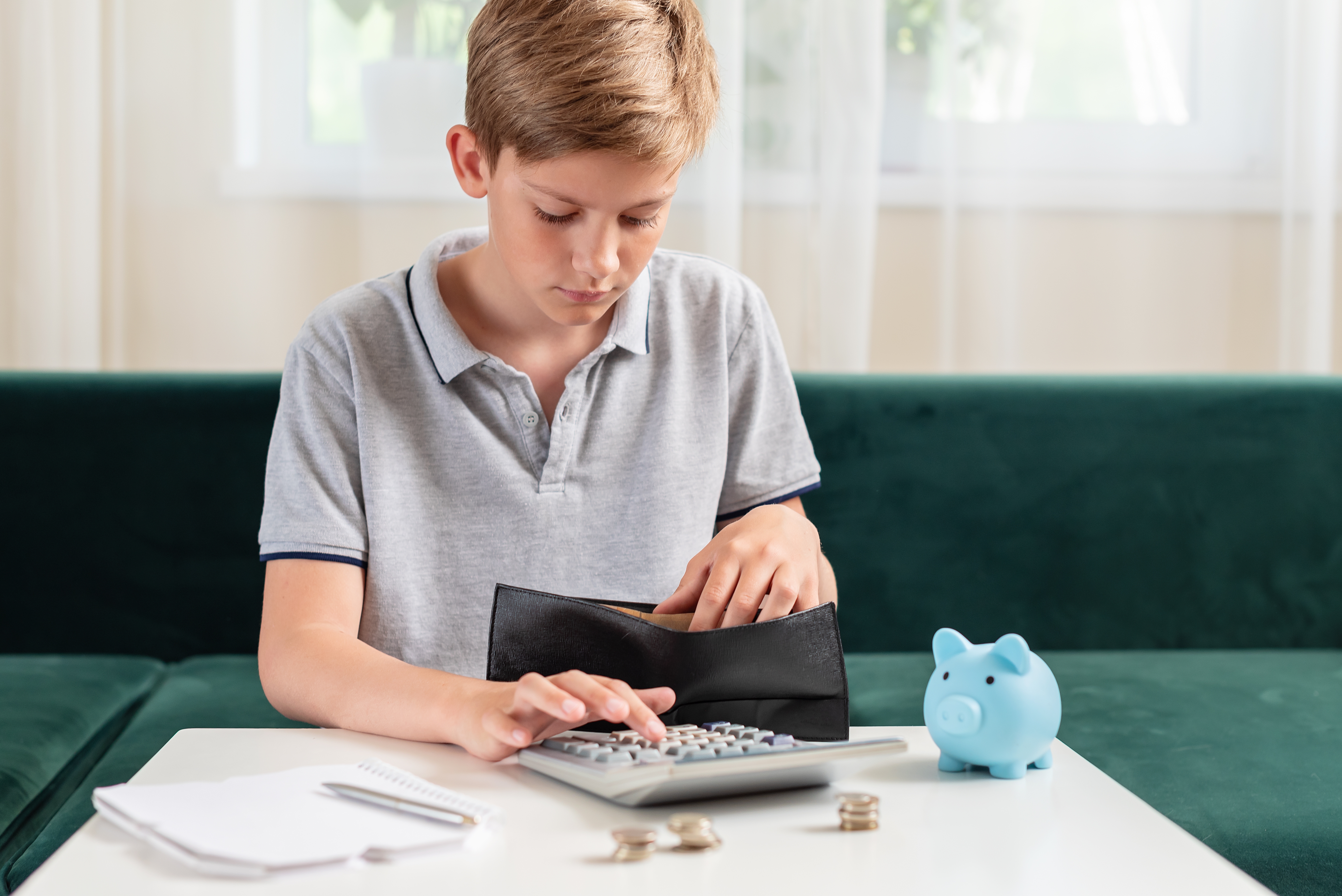 Un jeune garçon qui calcule son argent | Source : Shutterstock