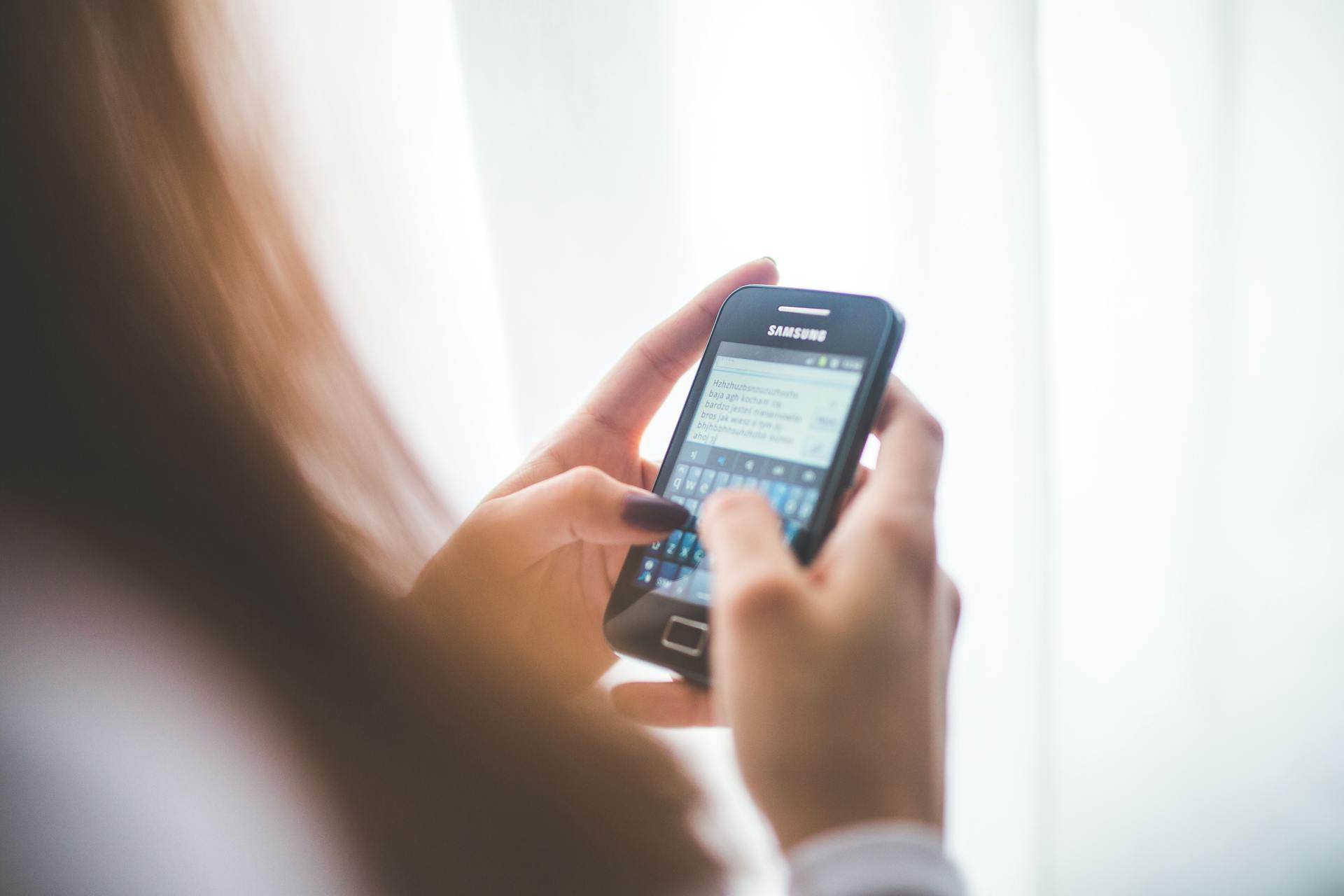 A woman using her phone | Source: Pexels