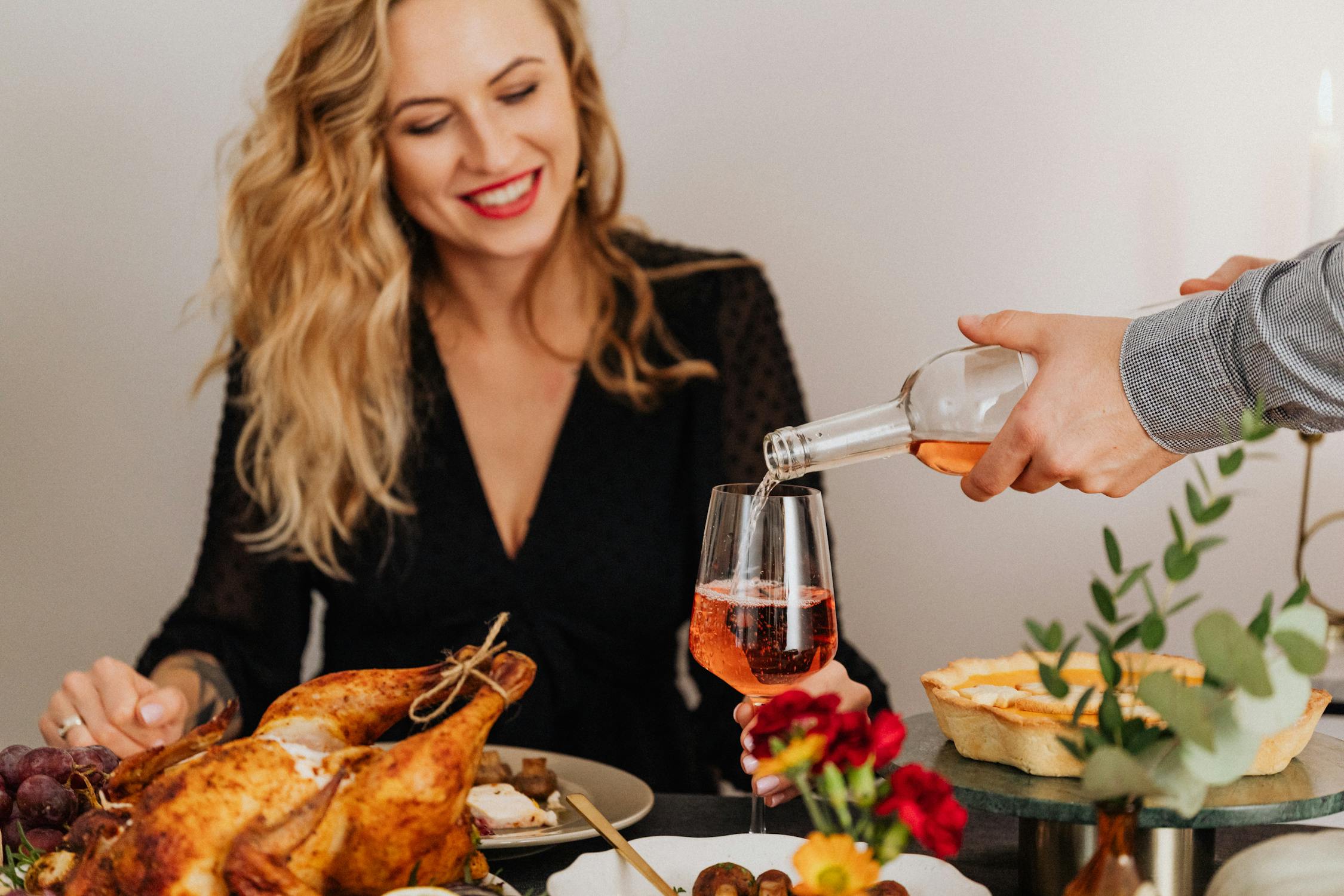 Une femme souriante lors d'un dîner de Thanksgiving | Source : Pexels