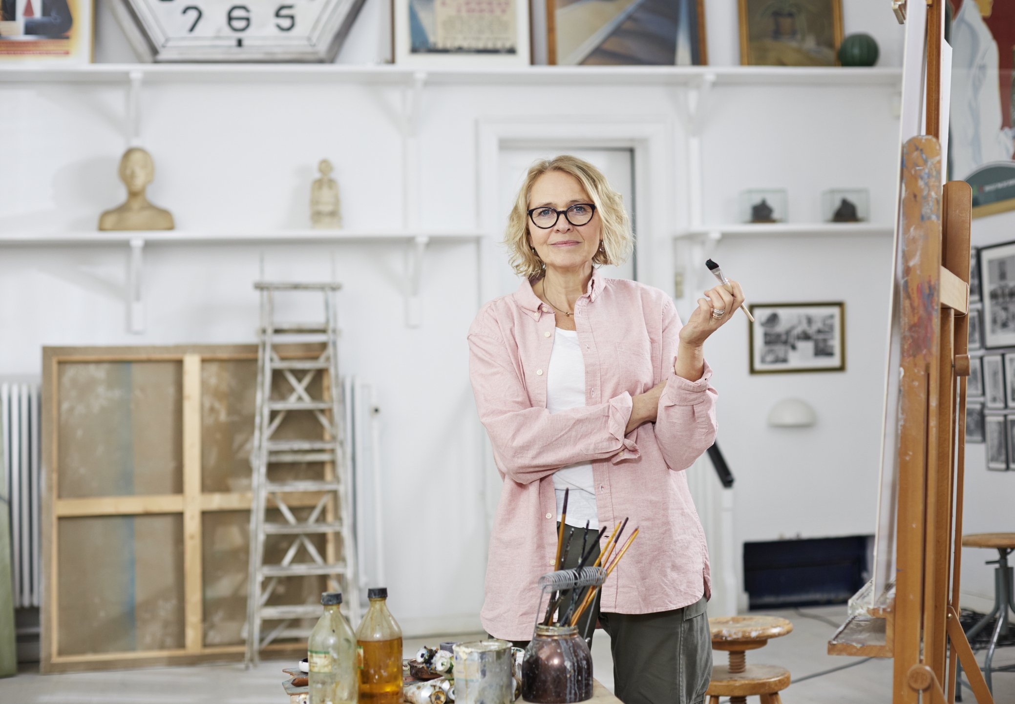 Une femme souriante dans un atelier  | source : Getty Images