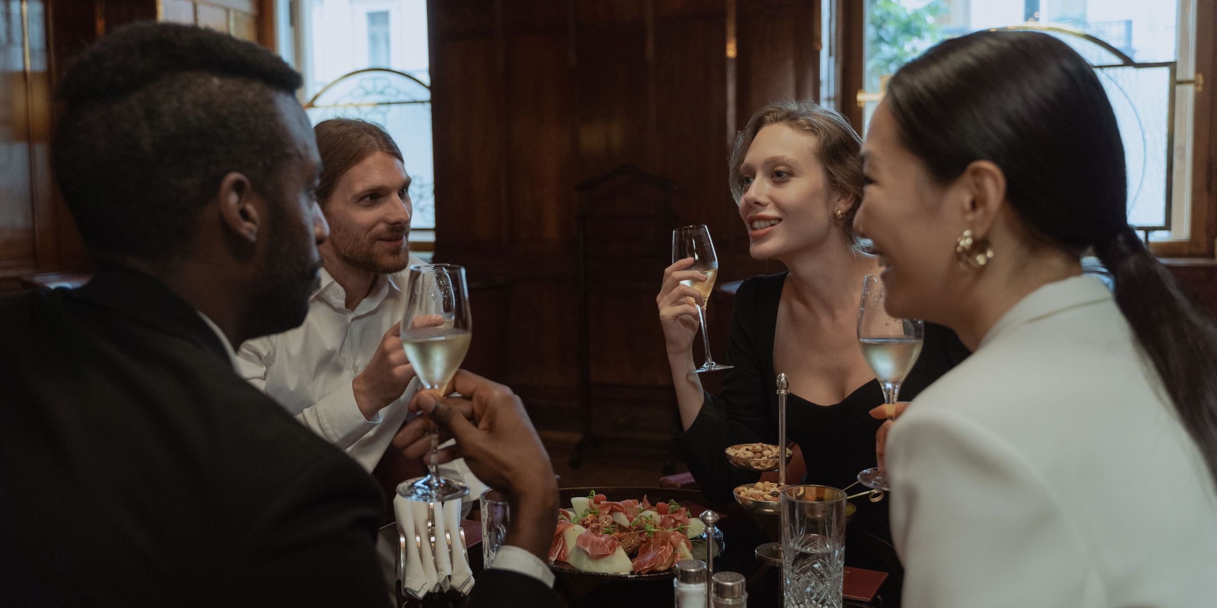 Un groupe de personnes en train de prendre un verre et de dîner dans un restaurant | Source : Pexels