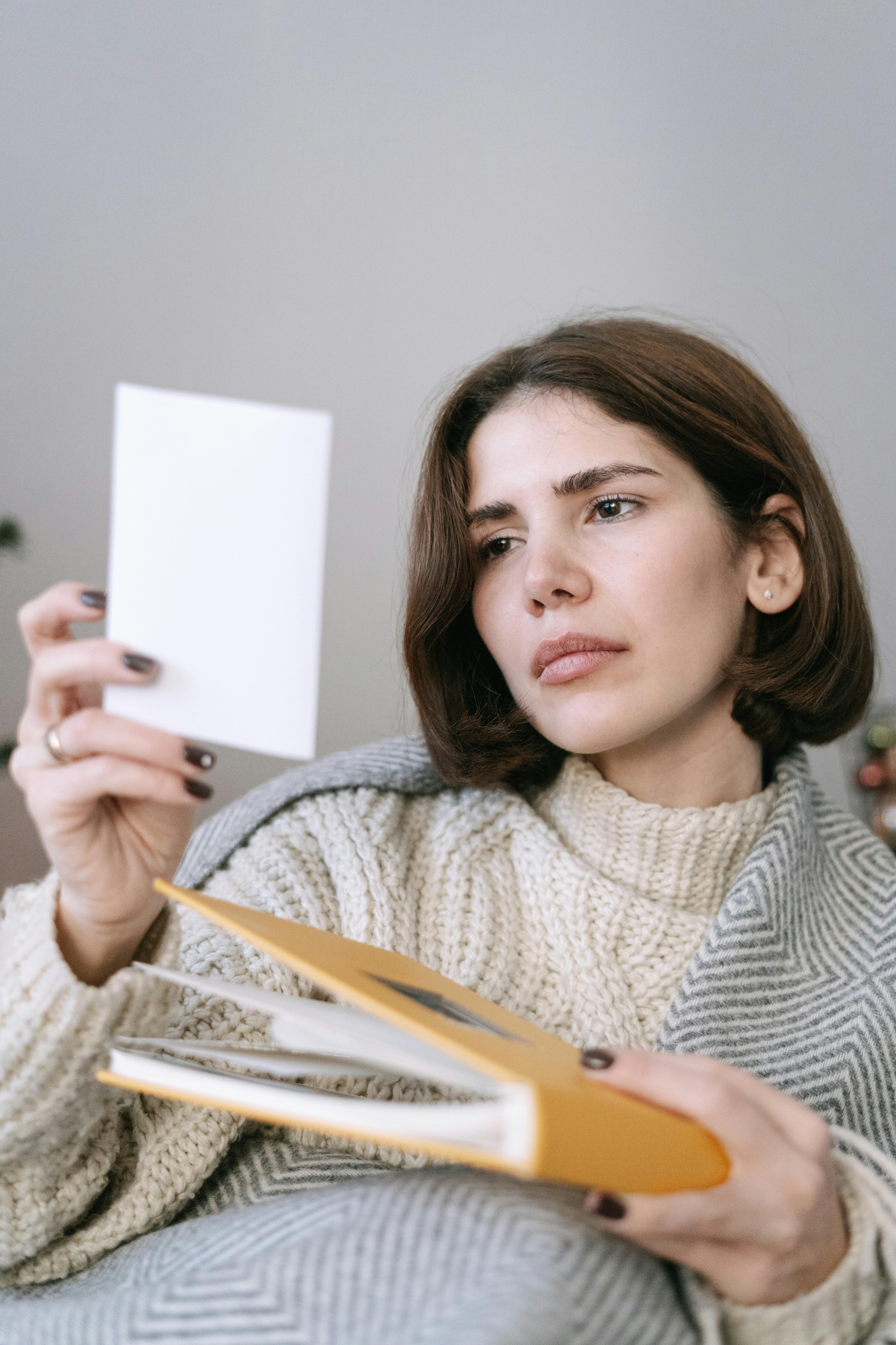 A woman looking at a photo | Source: Pexels