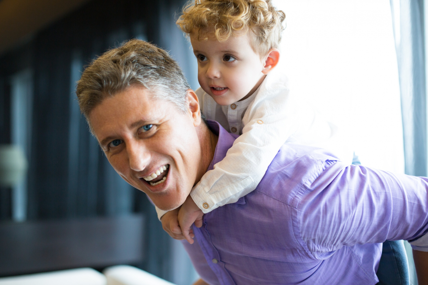 Un homme portant un petit garçon sur son dos | Source : Freepik