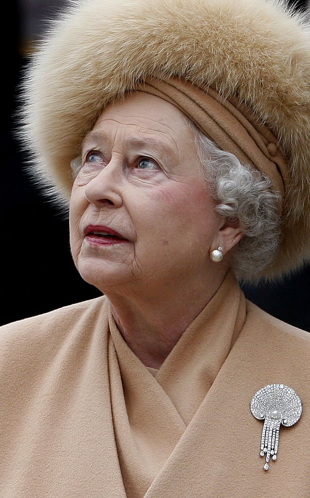 La Reine Elizabeth II de Grande-Bretagne regarde la statue de sa mère alors qu'elle assiste au dévoilement d'une nouvelle statue de la Reine Elizabeth, la Reine Mère, sur le Mall, le 24 février 2009 à Londres, en Angleterre. | Photo : Getty Images