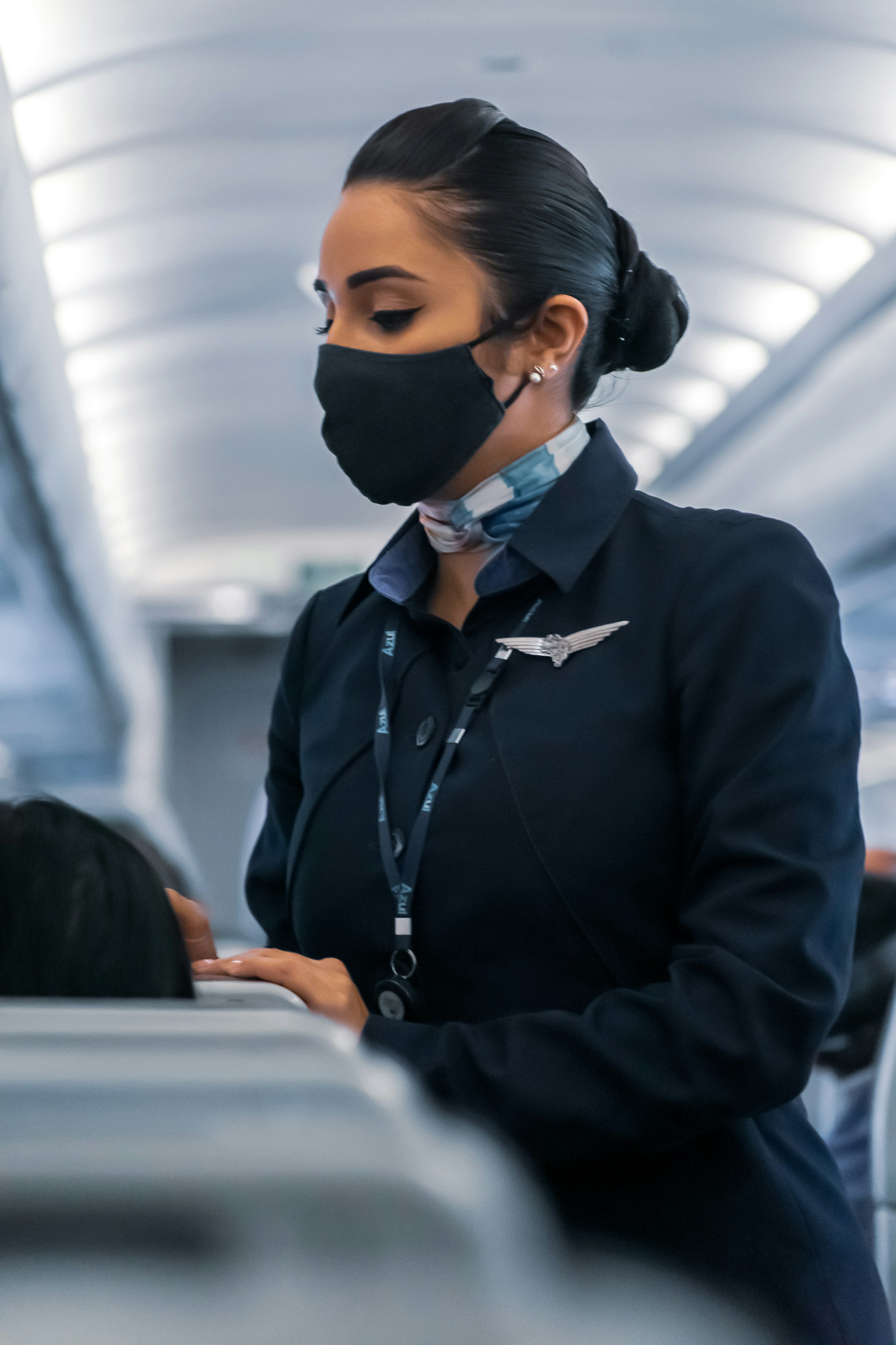 A flight attendant speaking to a passenger | Source: Unsplash