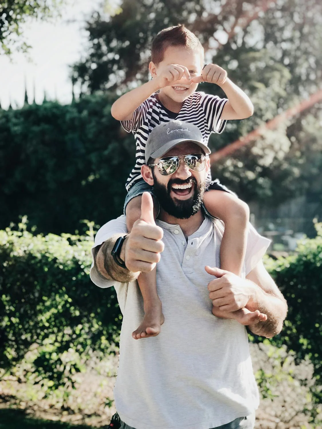 A man smiling with his son | Source: Pexels