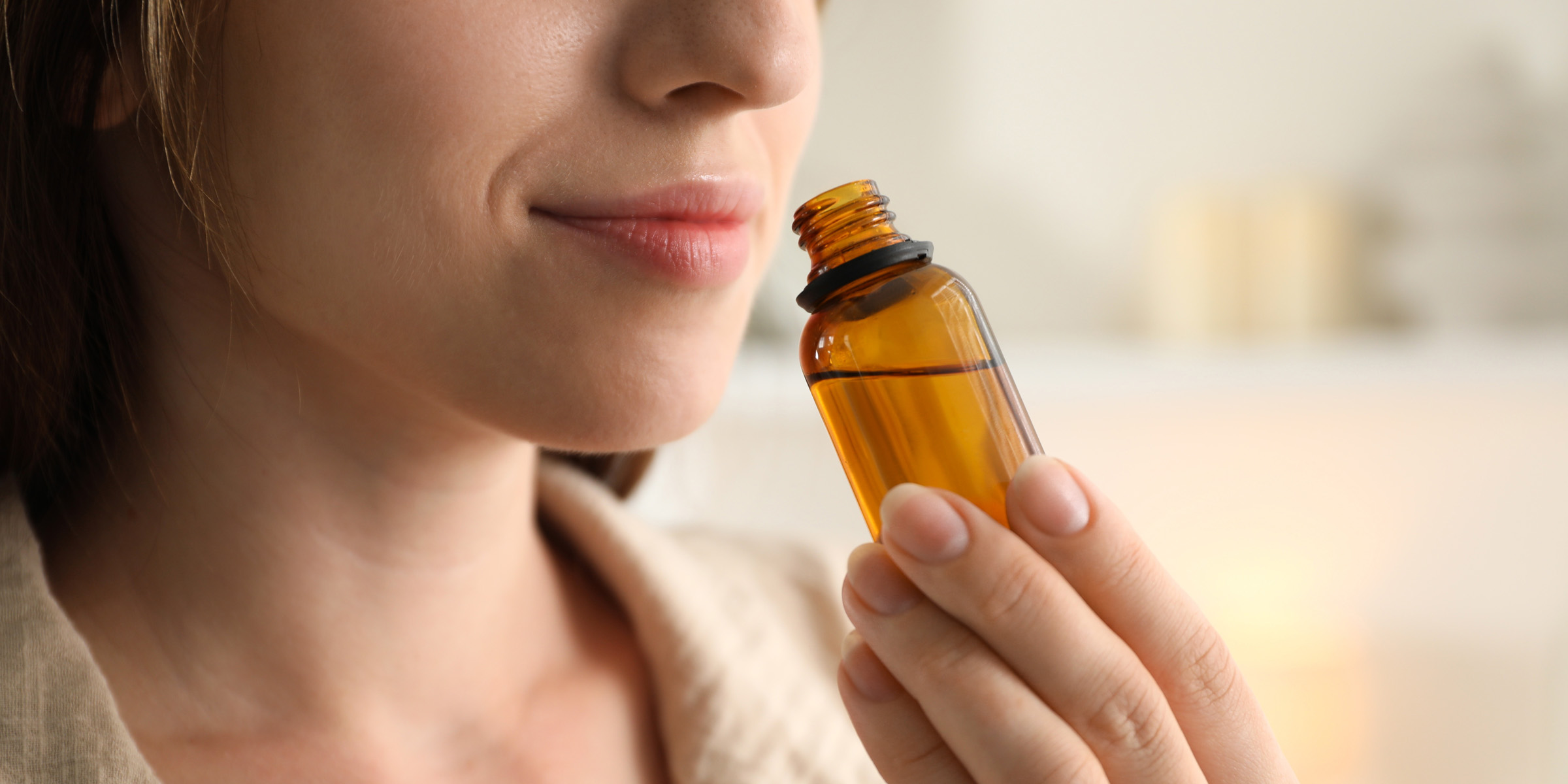 Femme sentant l'odeur d'un diffuseur | Source : Shutterstock