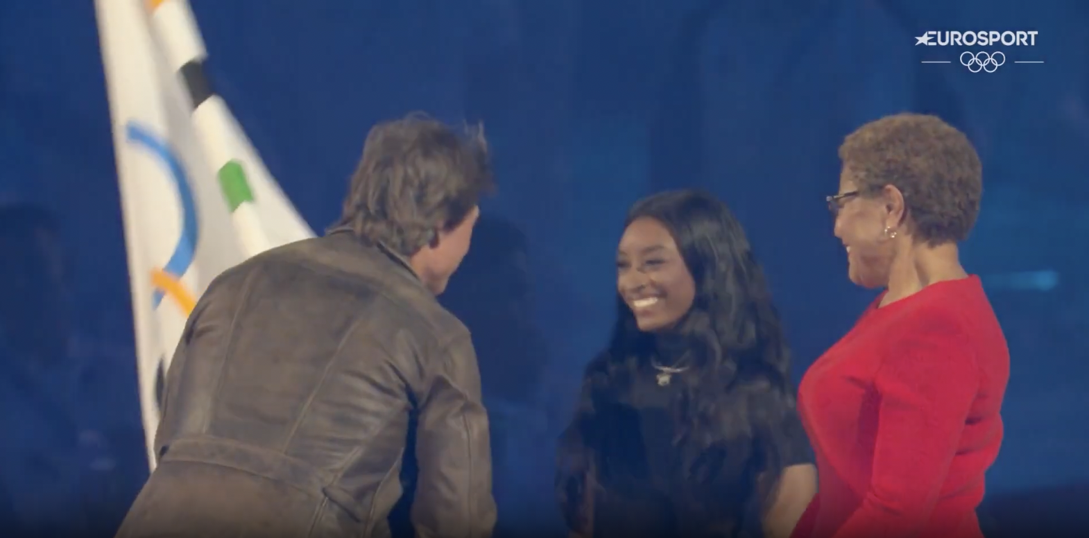 Tom Cruise arrivant sur la scène principale pour prendre le drapeau des mains de Simone Biles et Karen Bass, posté le 12 août 2024 | Source : YouTube/Eurosport