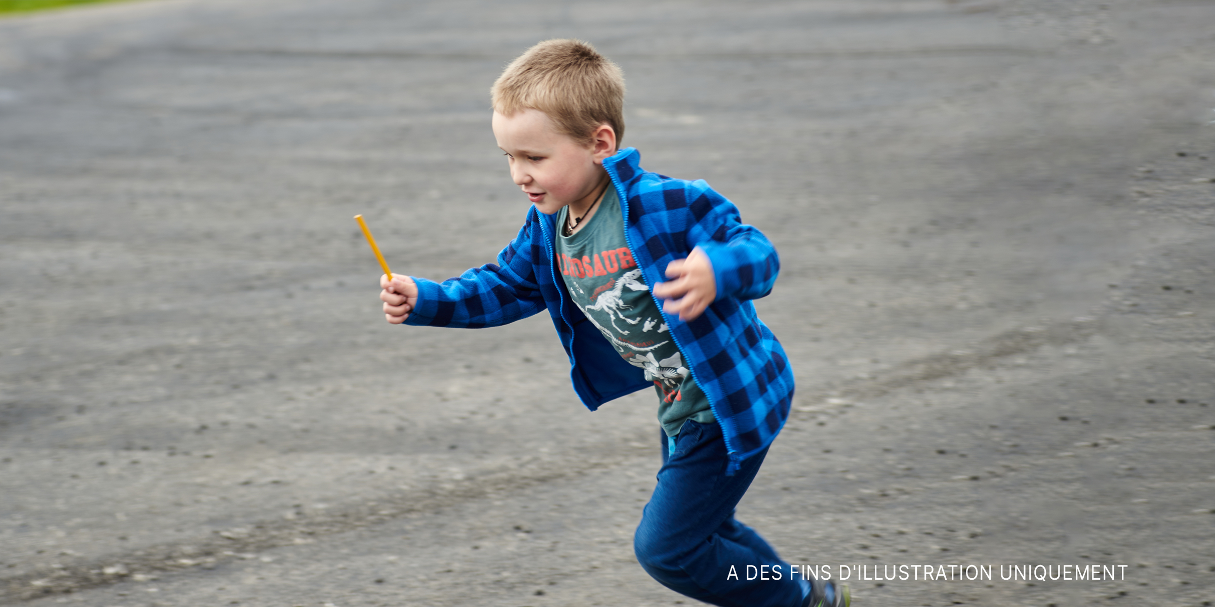 Un petit garçon qui court sur la route | Source : Shutterstock