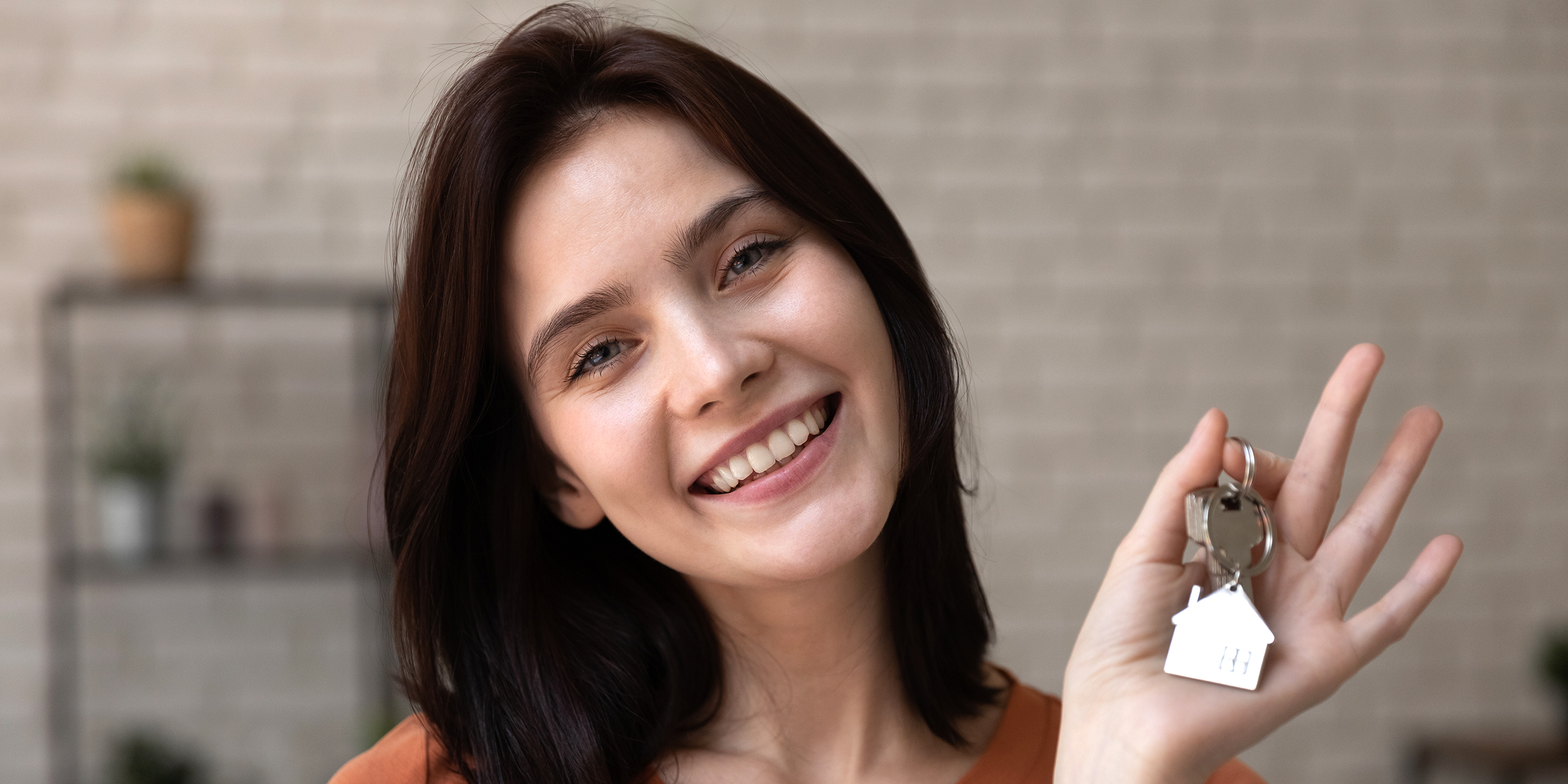 Une jeune femme tenant des clés de maison | Source : Shutterstock