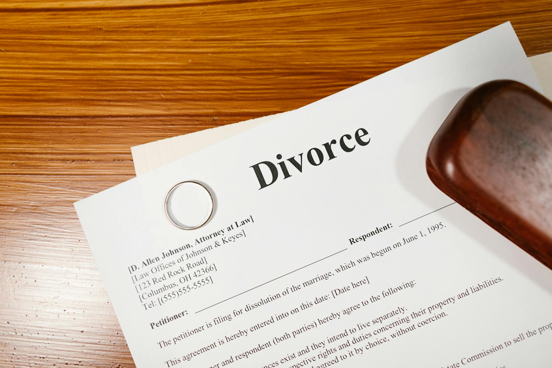 Gros plan sur des papiers de divorce posés sur une table brune | Source : Pexels