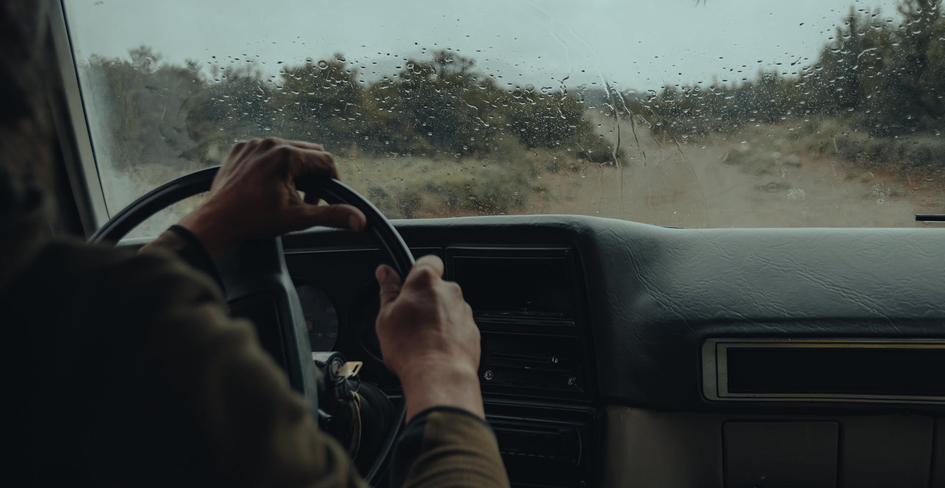 Un homme conduisant une voiture par un jour de pluie | Source : Pexels