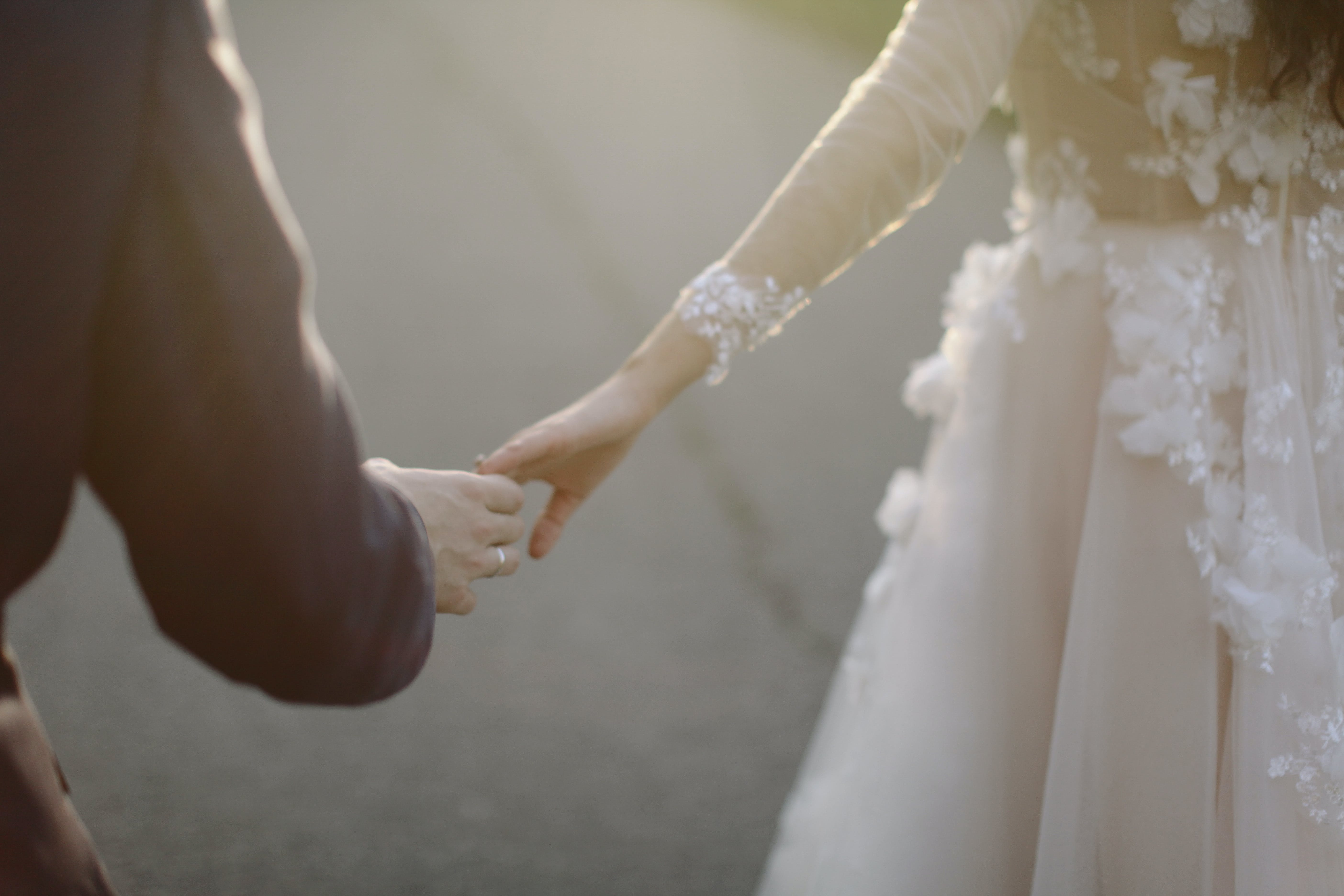 Une mariée et un marié se touchant les mains | Source : Pexels