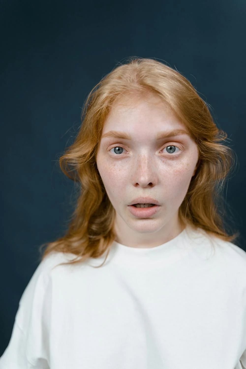 A shocked red-haired woman | Source: Pexels