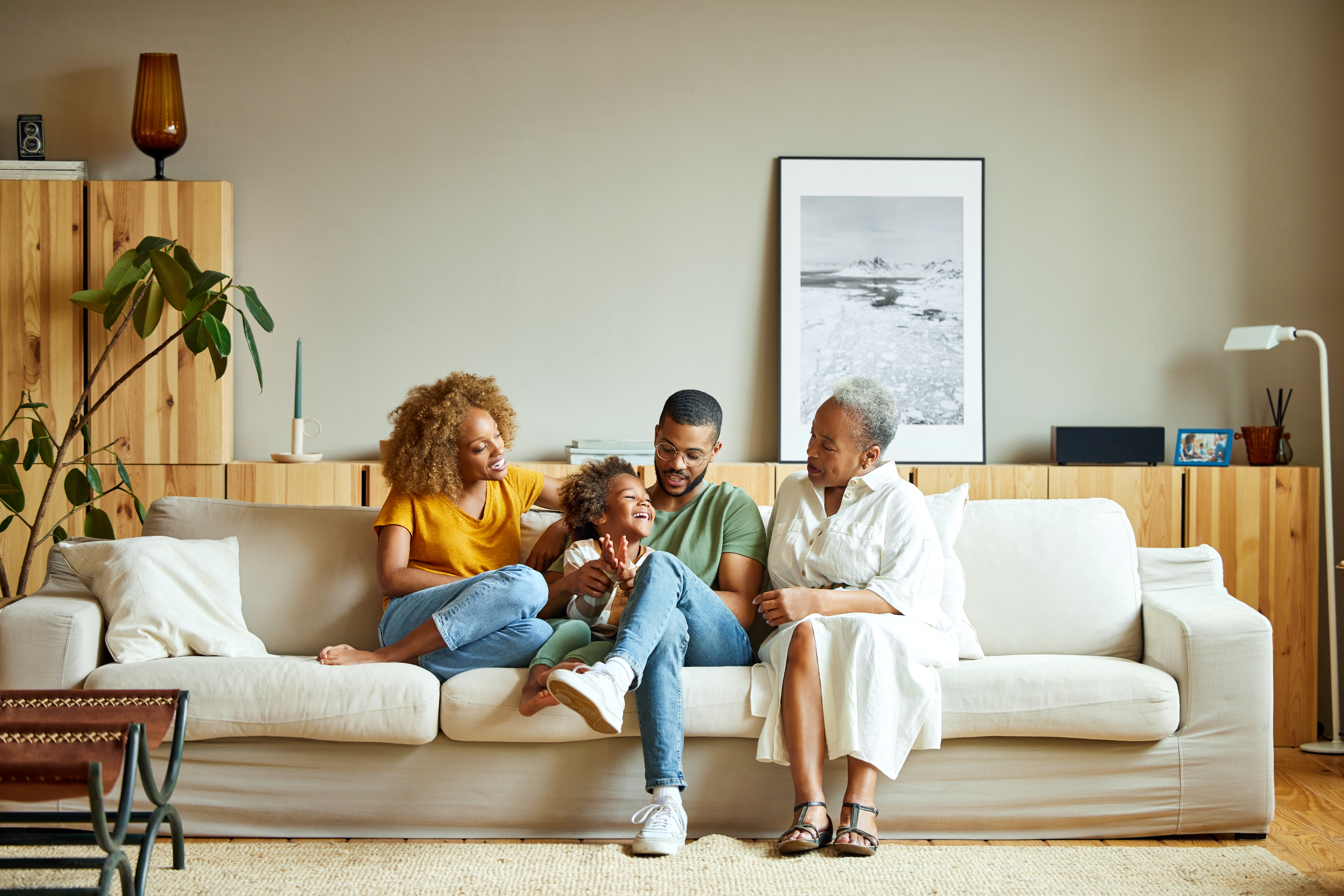 Une famille afro-américaine heureuse s'amuse dans le salon | Source : Getty Images