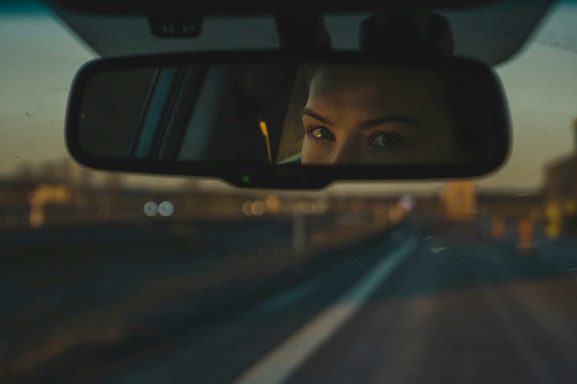 Une femme qui regarde dans le rétroviseur. | Source : Unsplash