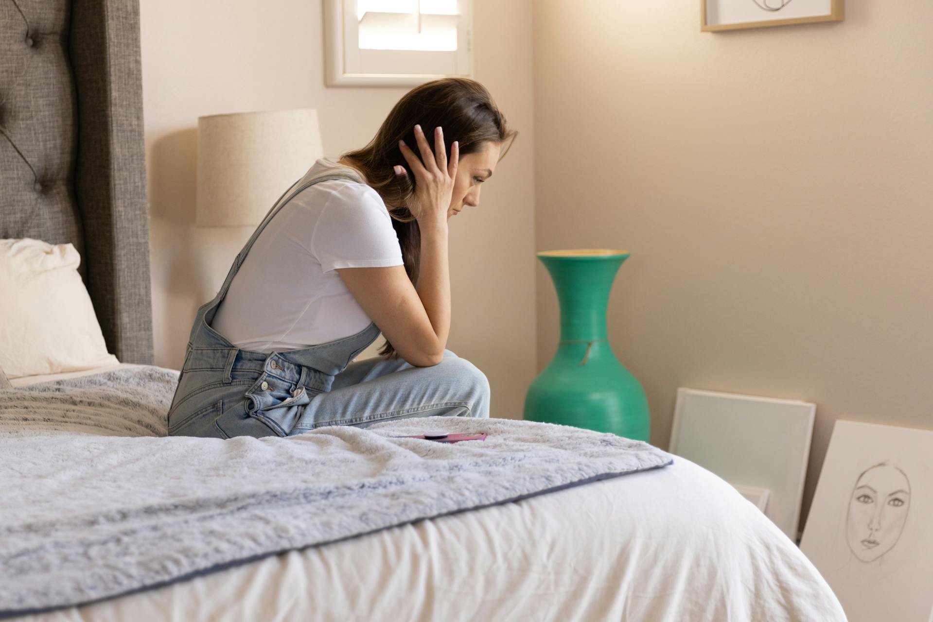 Une femme en détresse assise sur le lit | Source : Pexels