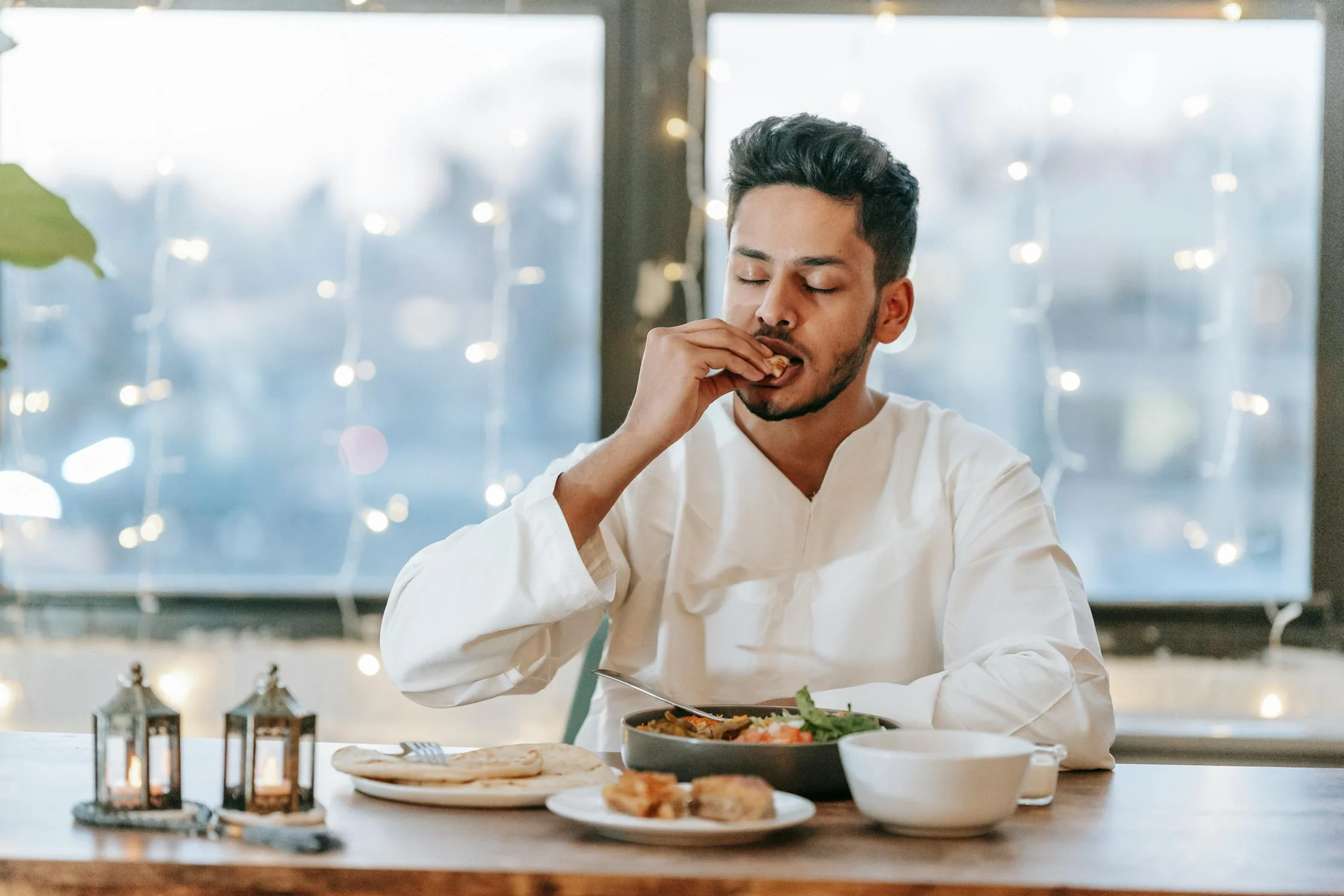 Un homme mangeant avec ses mains | Source : Pexels