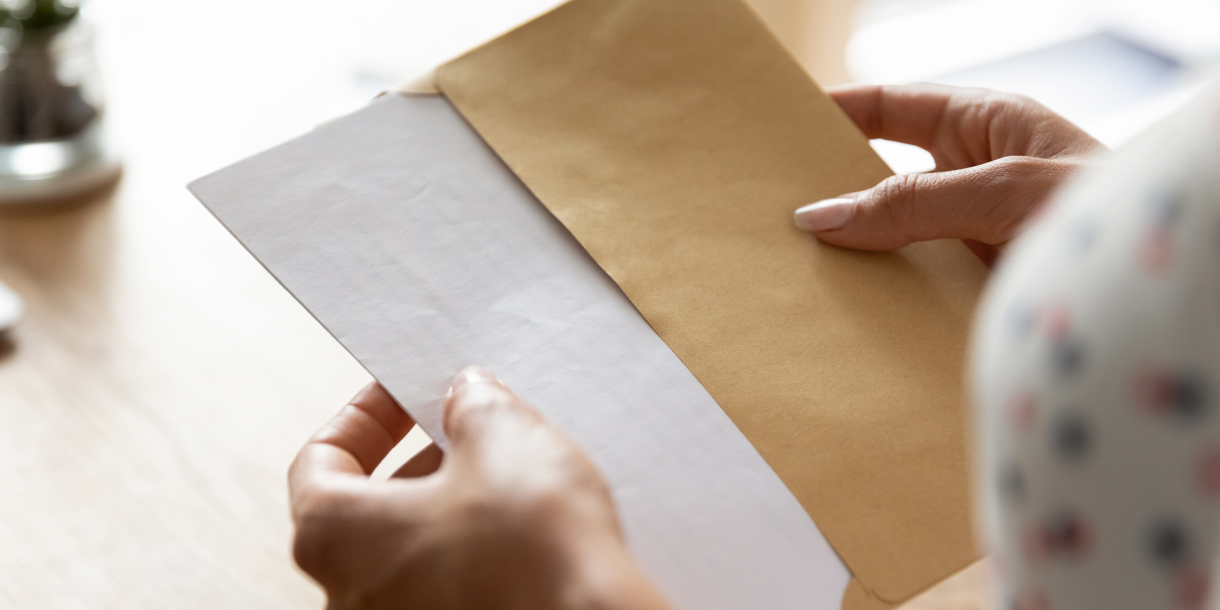 Une femme tenant une enveloppe | Source : Shutterstock