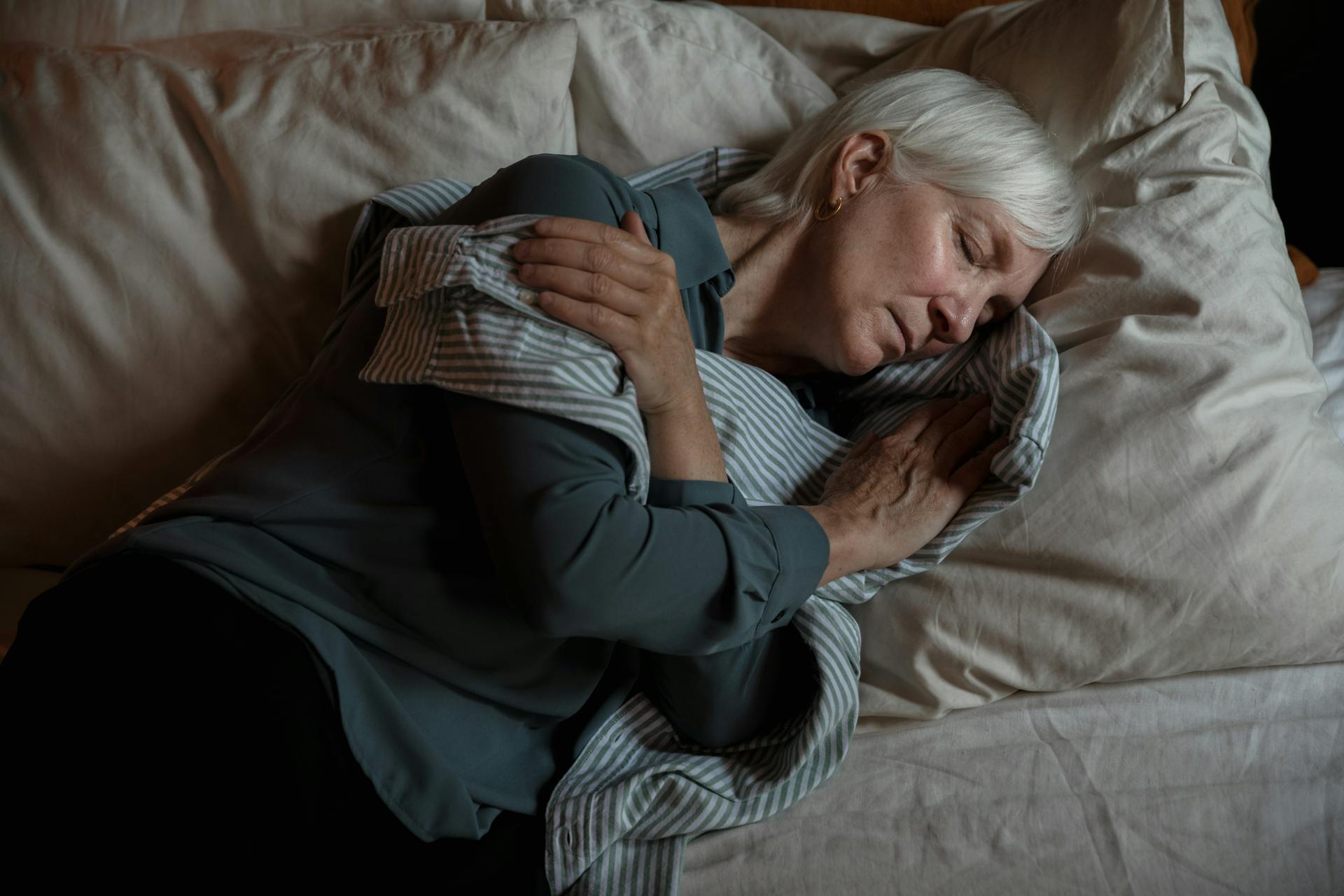 An elderly woman hugging a man's shirt | Source: Pexels