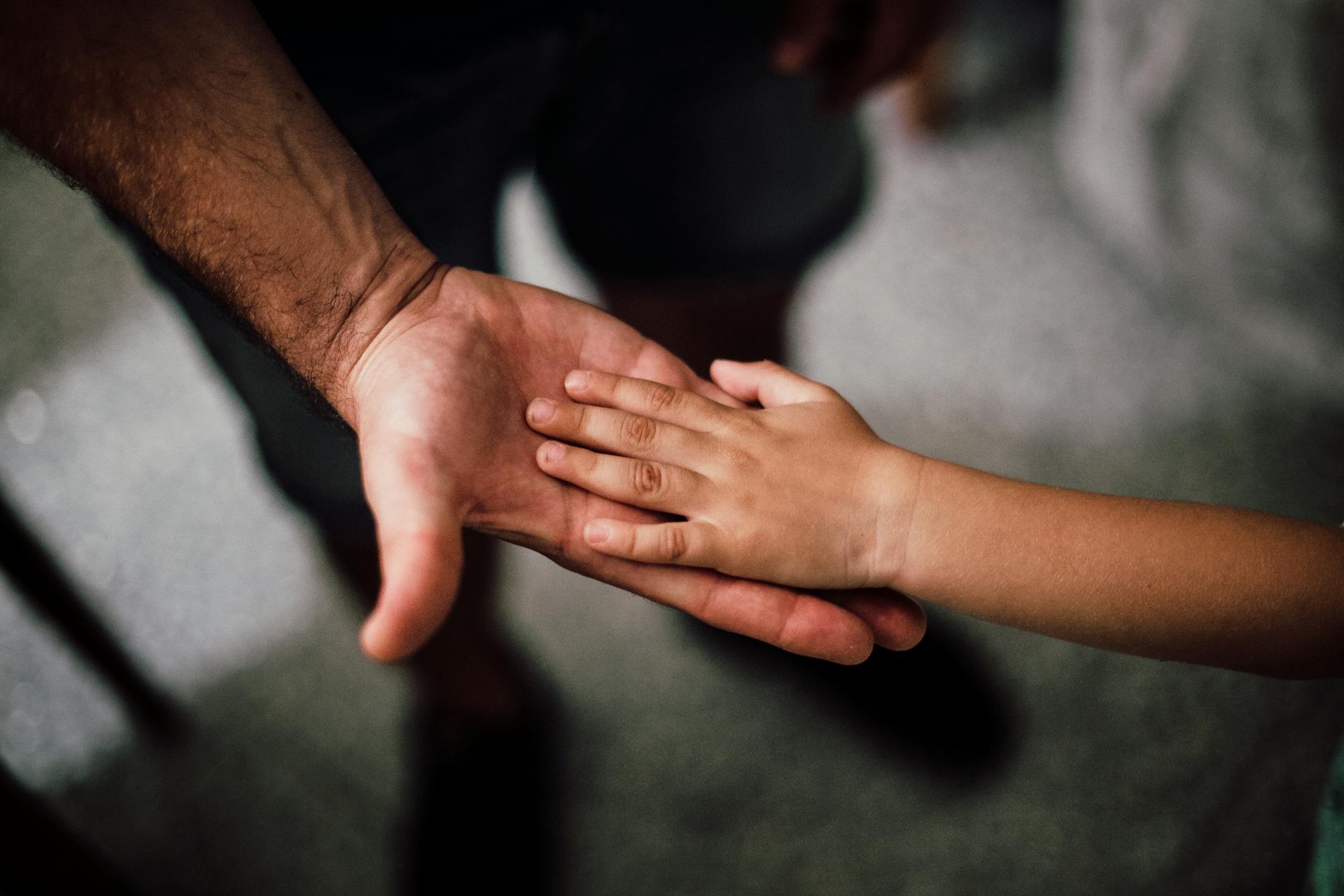 La main d'un enfant reposant sur celle de son père | Source : Pexels