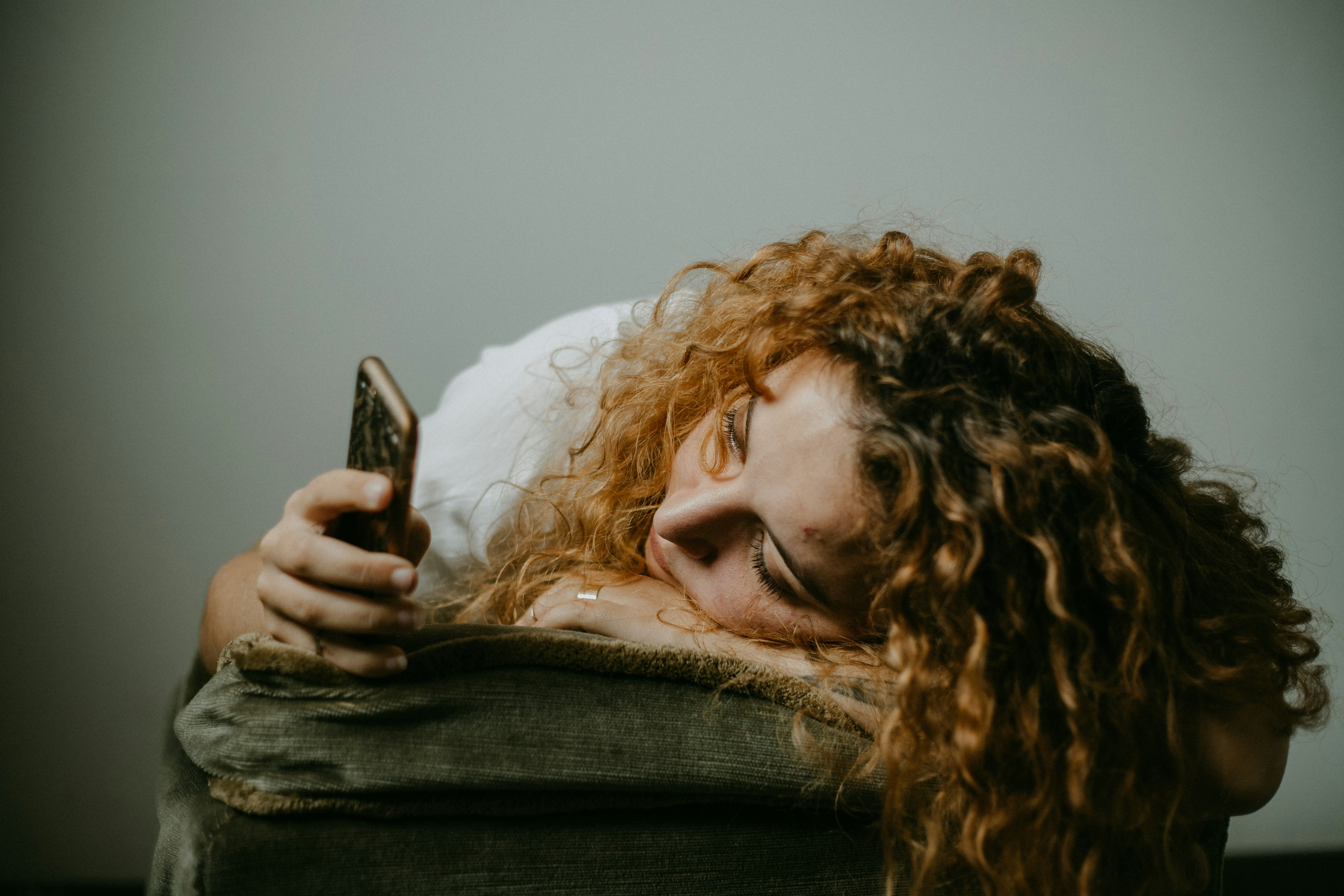 Une femme triste sur son téléphone | Source : Unsplash
