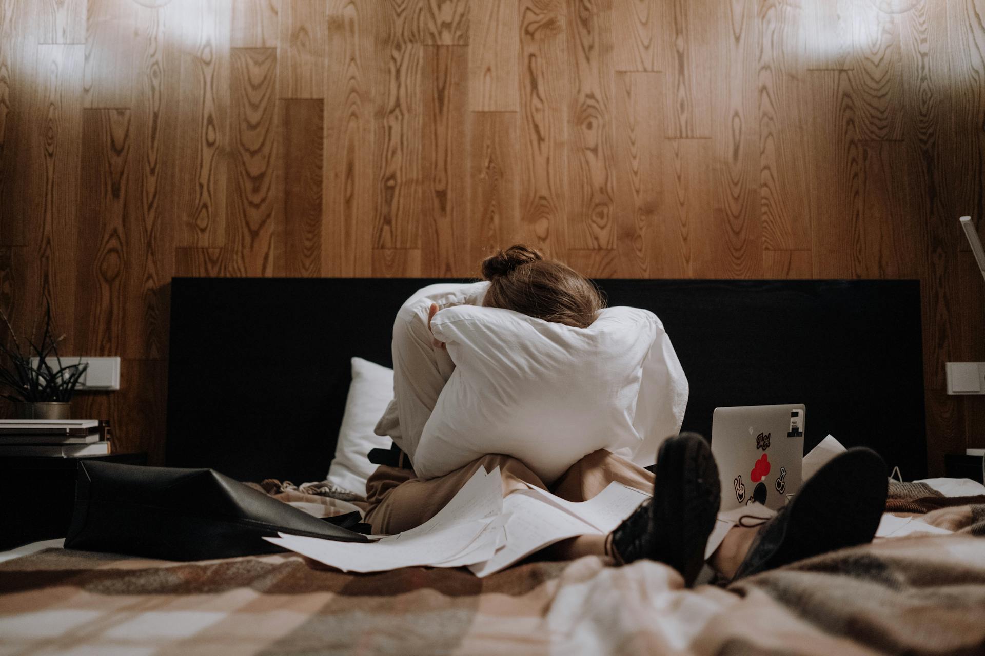 Une femme au cœur brisé qui pleure dans son oreiller dans la chambre à coucher | Source : Pexels