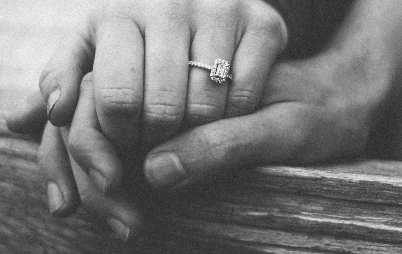 Grayscale photo of a couple holding hands | Source: Unsplash