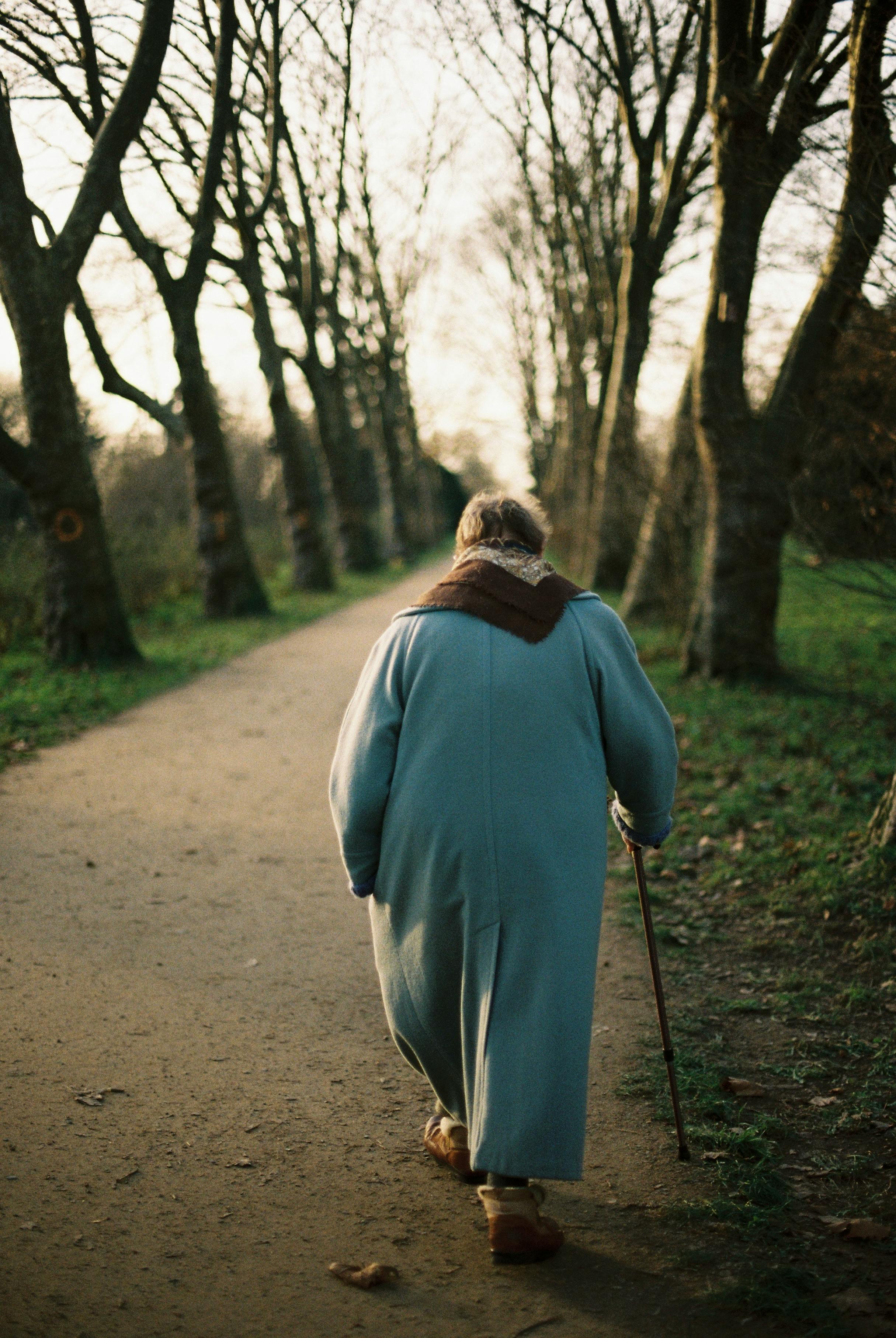 An elderly woman walking in a park | Source: Pexels