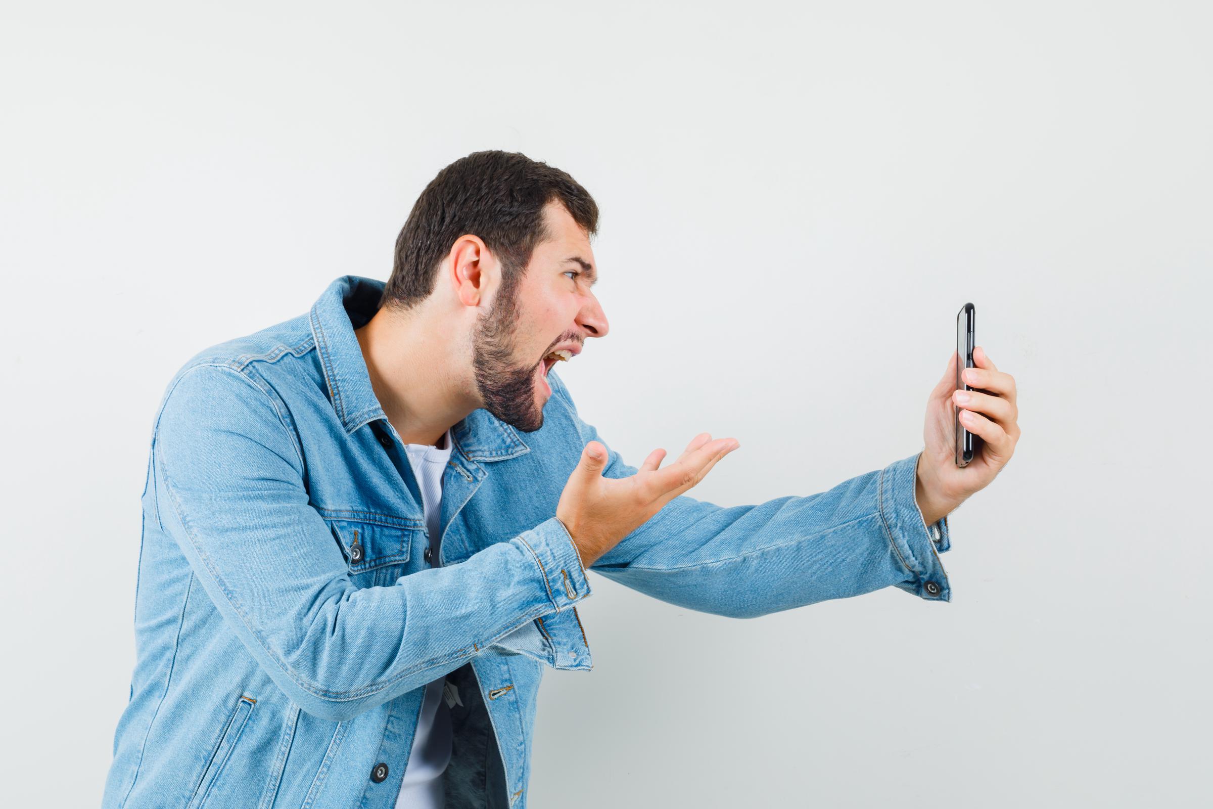 Un homme agité qui parle au téléphone | Source : Freepik