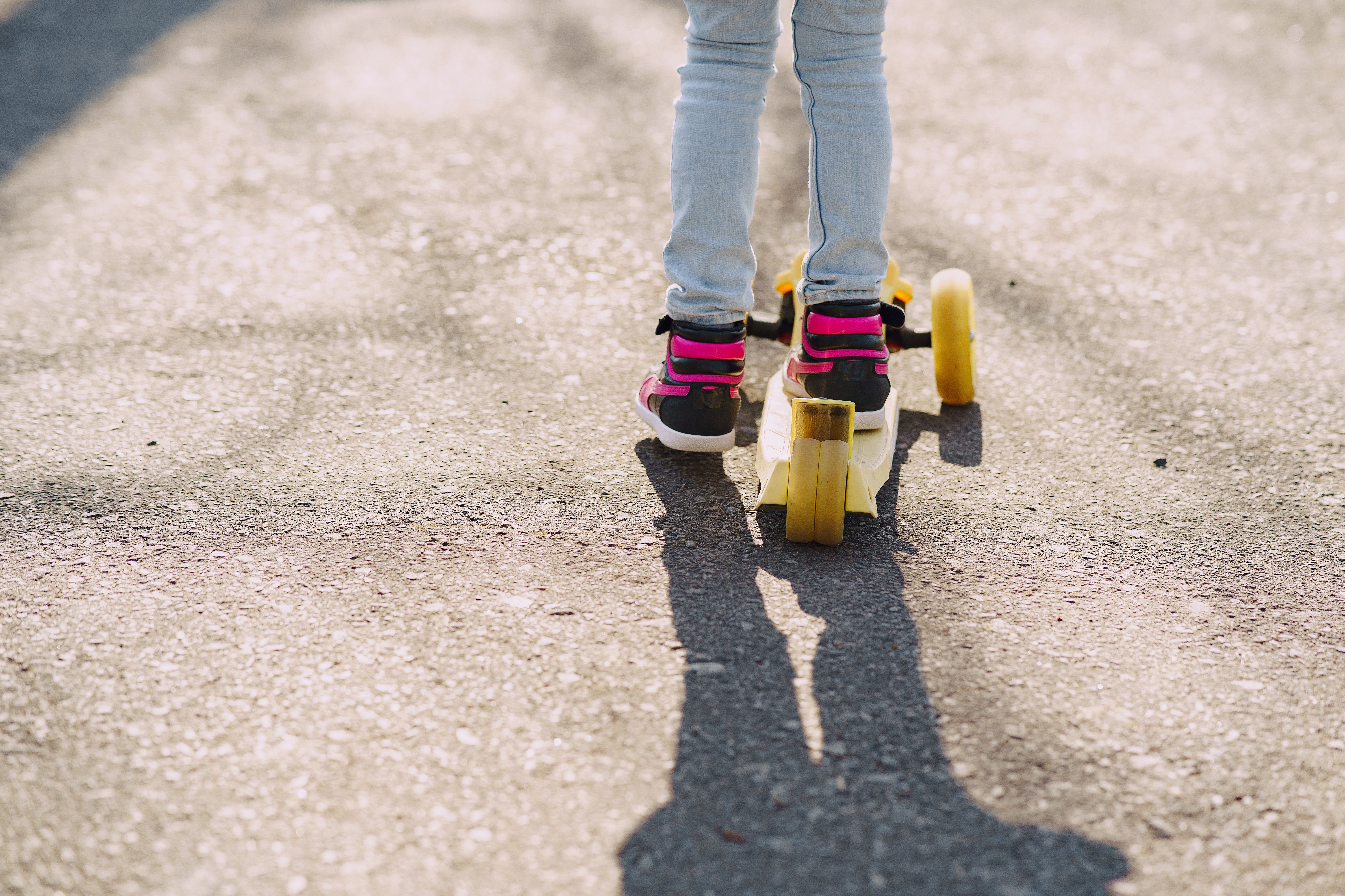 Un enfant en trottinette dehors | Source : Pexels