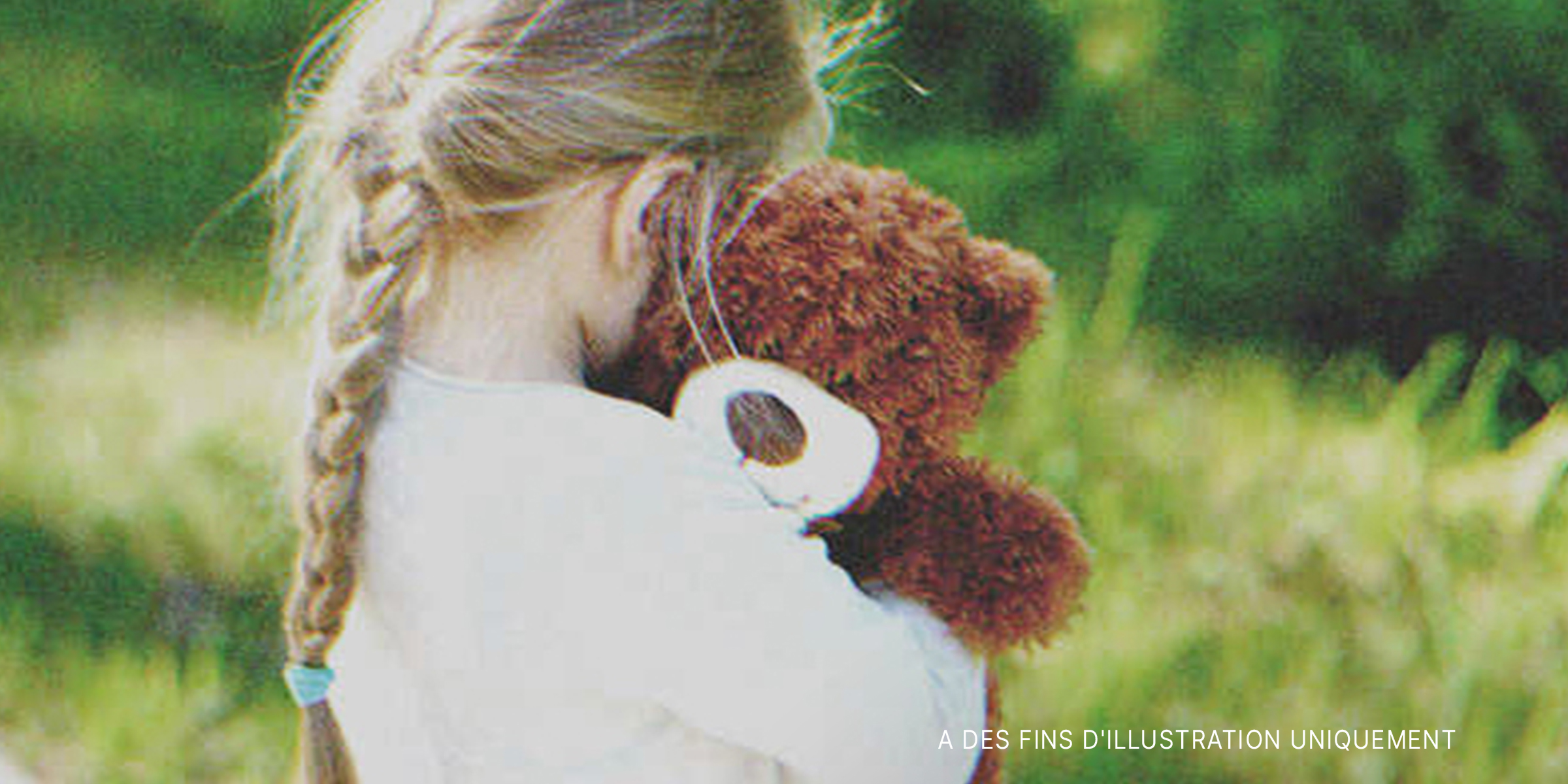 Une petite fille tenant un ours en peluche | Source : Shutterstock
