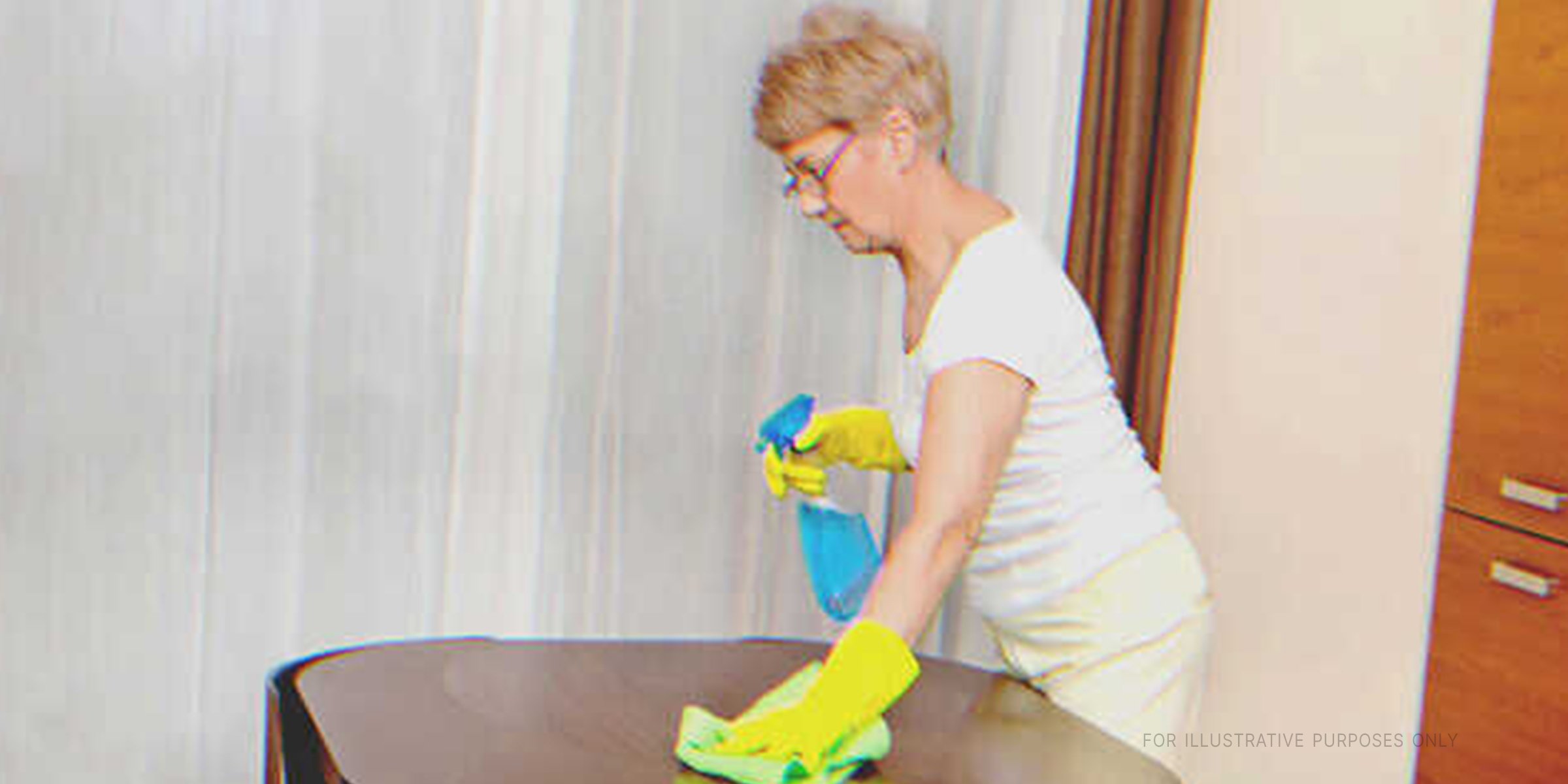 Une femme âgée nettoyant une table. | Source : Shutterstock