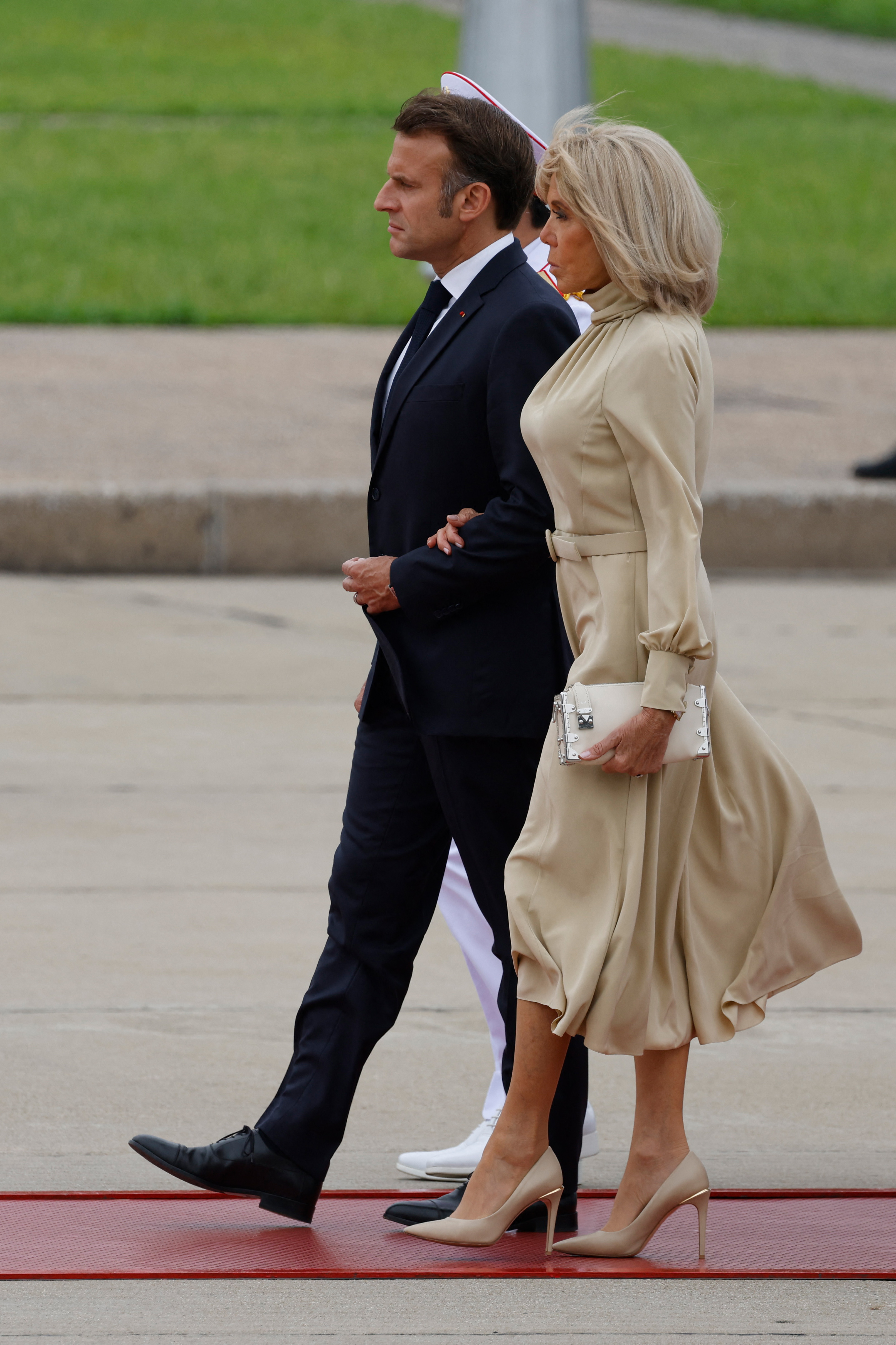 Le président français Emmanuel Macron (à gauche) et son épouse Brigitte Macron participent à une cérémonie de dépôt de la gerbe au monument des héros et martyrs nationaux à Hanoï, le 26 mai 2025 I Source : Getty Images