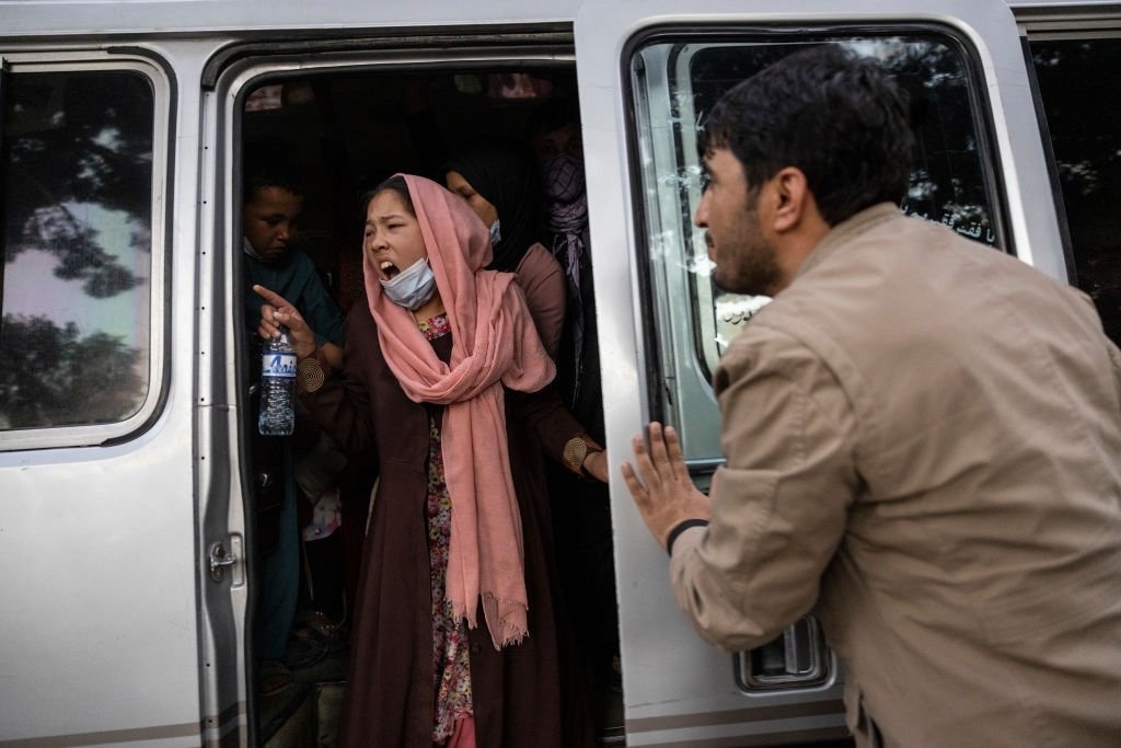 Une femme crie pour que sa famille se dépêche alors que des Afghans déplacés des provinces du nord sont évacués. | Photo : Getty Images