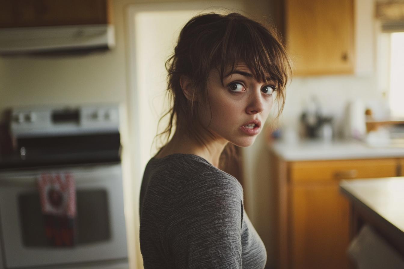 Shocked woman in kitchen | Source: Midjourney