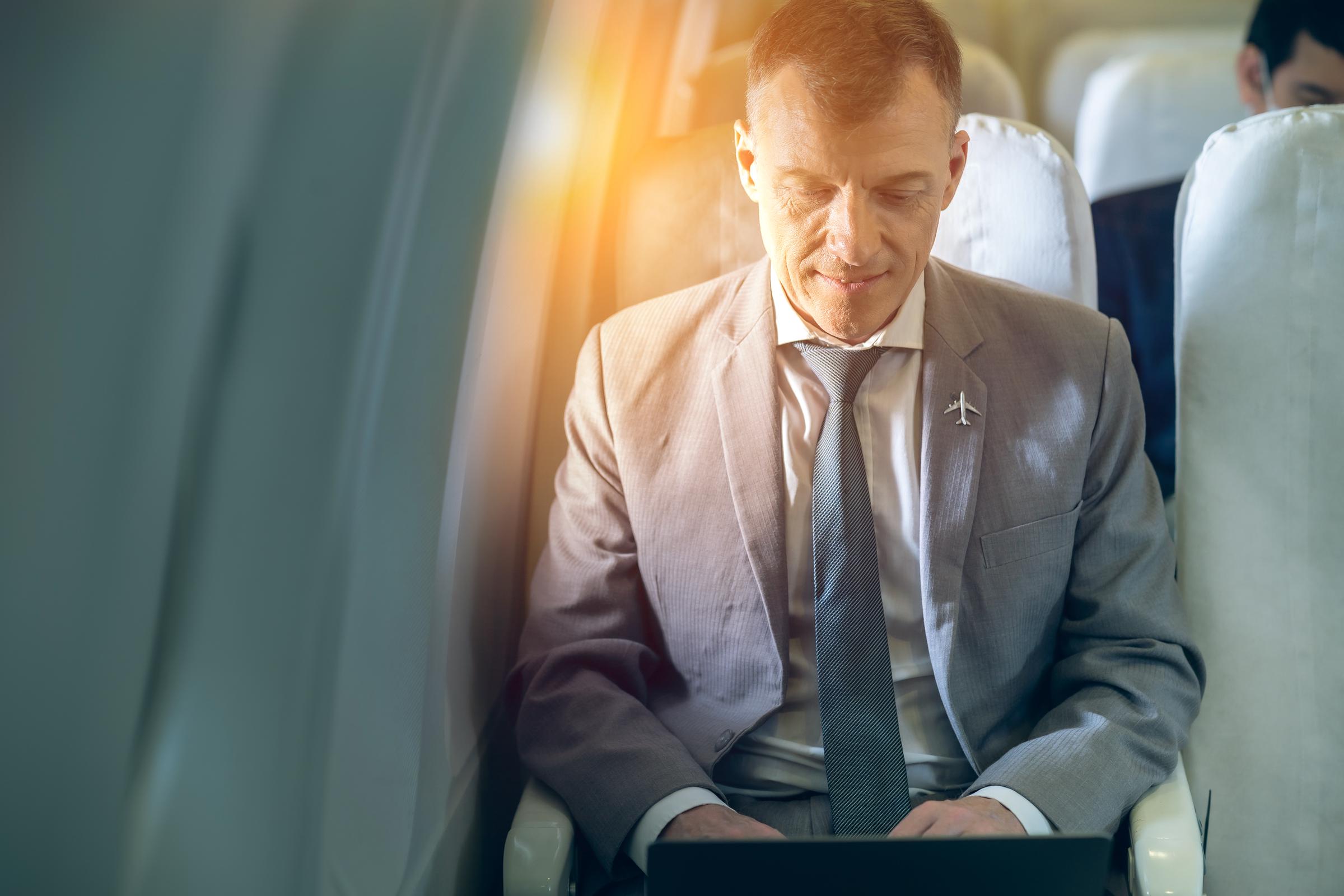 Homme d'affaires à l'intérieur d'un avion | Source : Shutterstock