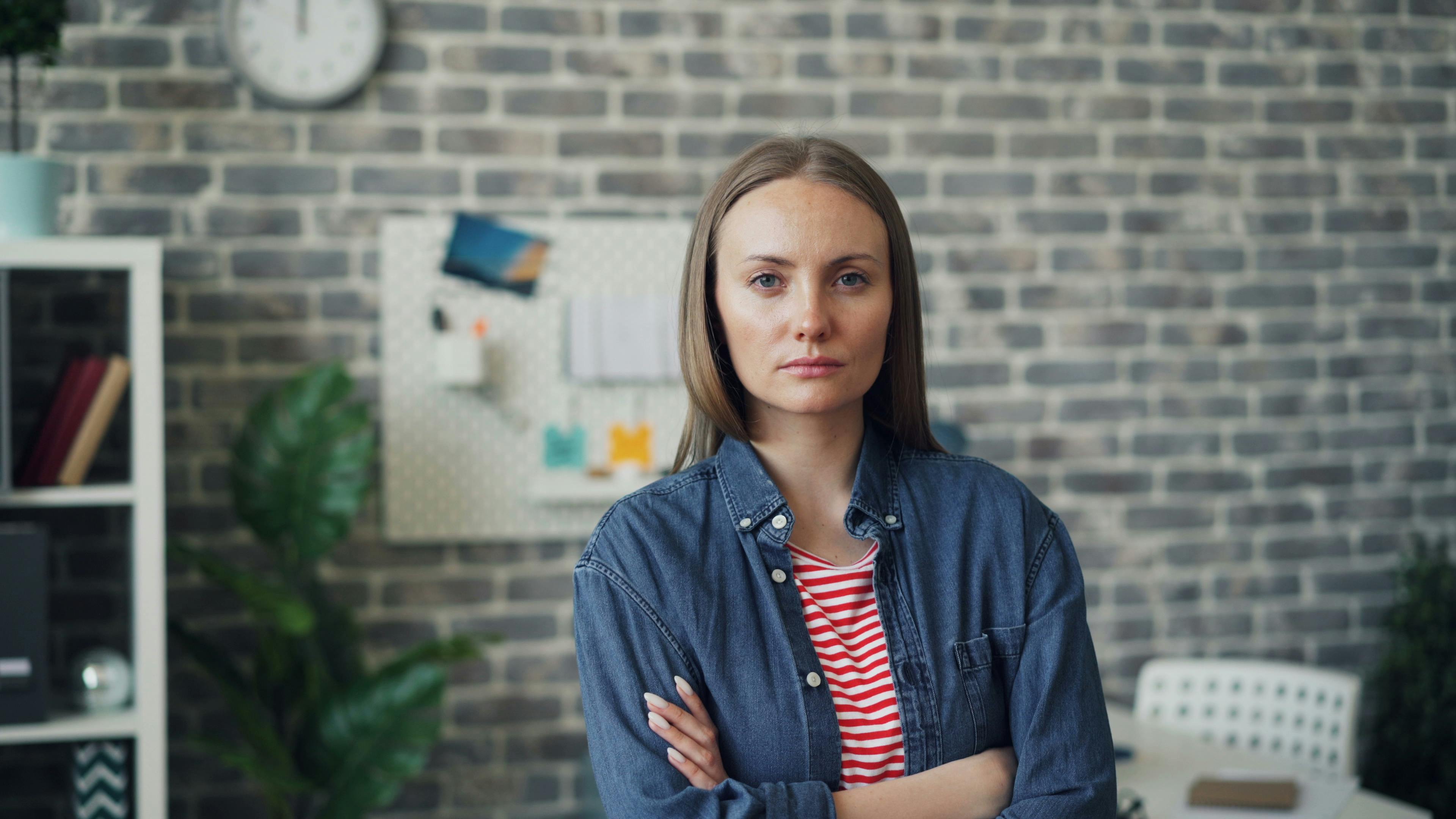 Femme sérieuse aux mains croisées | Source : Pexels